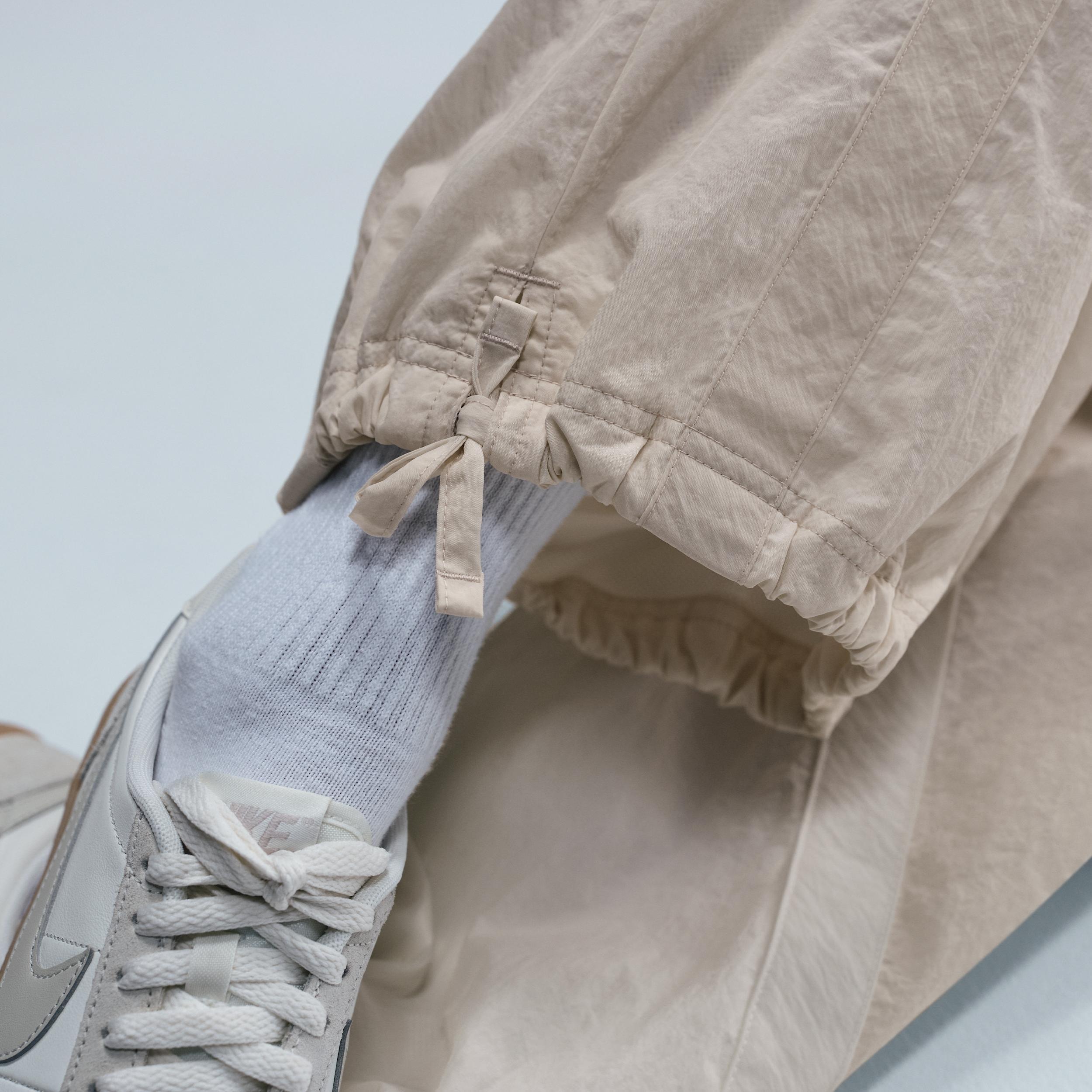 Nike Womens Sportswear Street Mid-Rise Loose Woven Open-Hem Pants in Sail/Light Orewood Brown/Light Orewood Brown Product Image