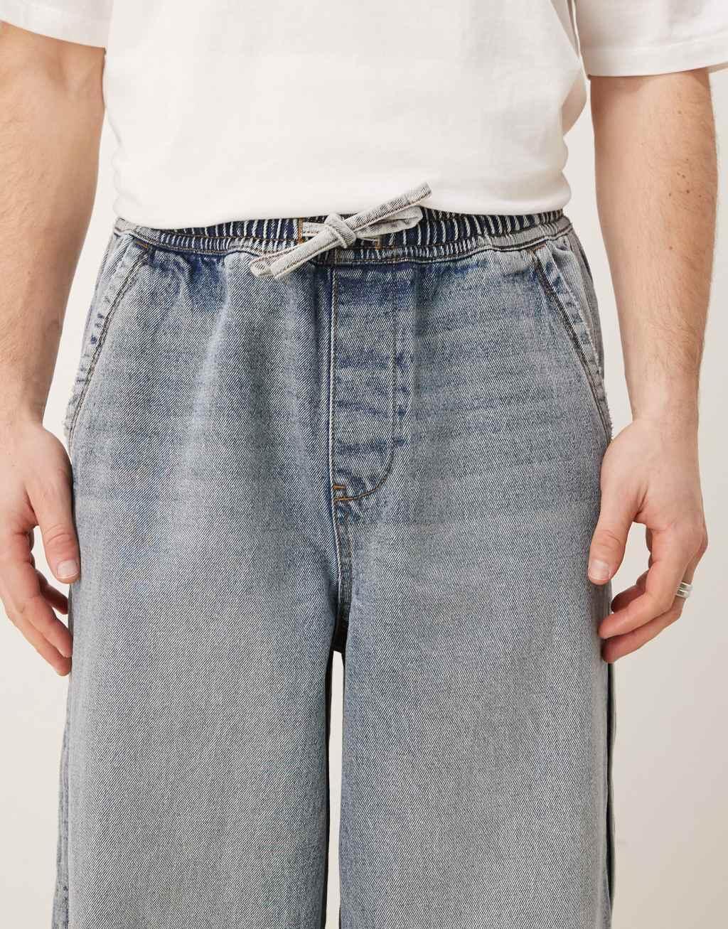 ASOS DESIGN super baggy jeans with elastic waist in mid wash blue Product Image