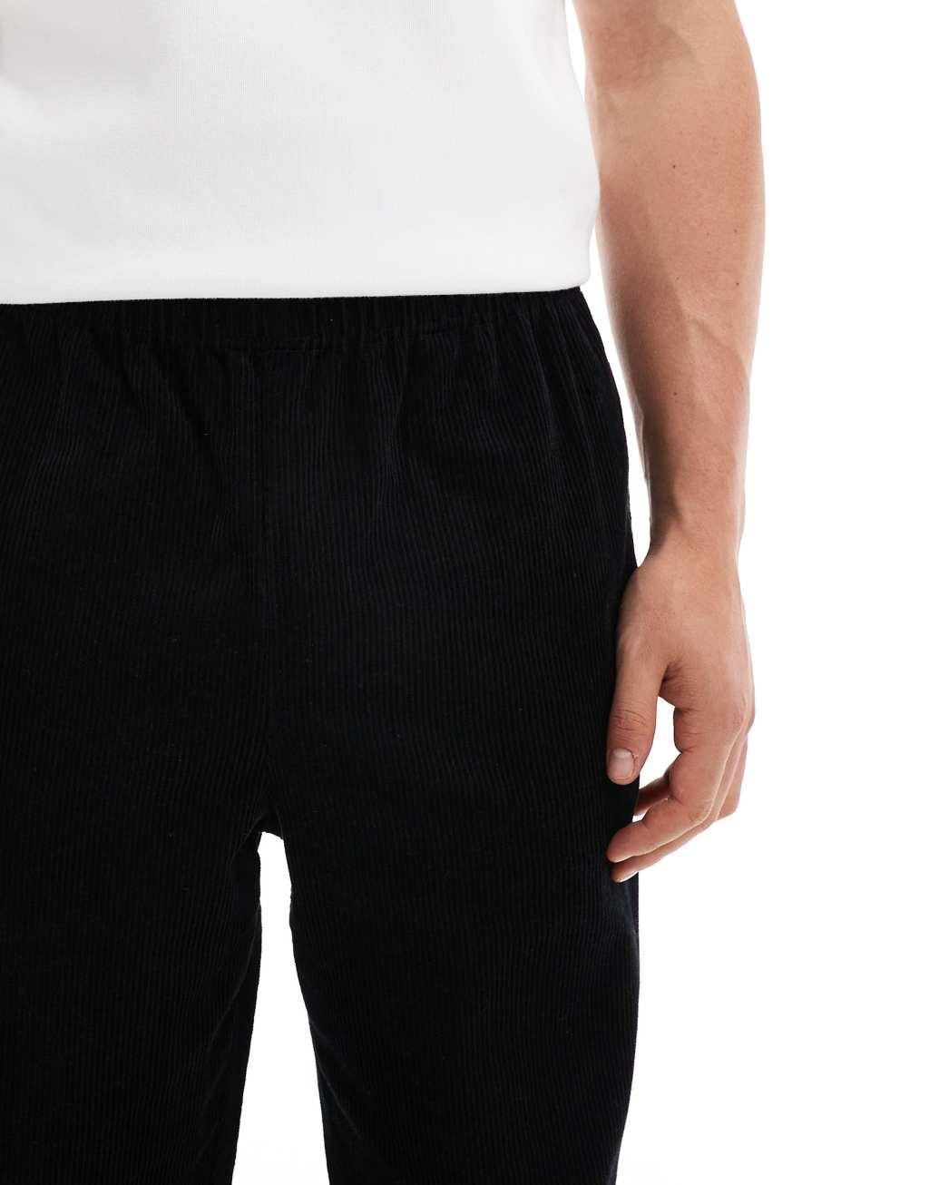 ASOS DESIGN baggy cord pants with side taping in black  Product Image