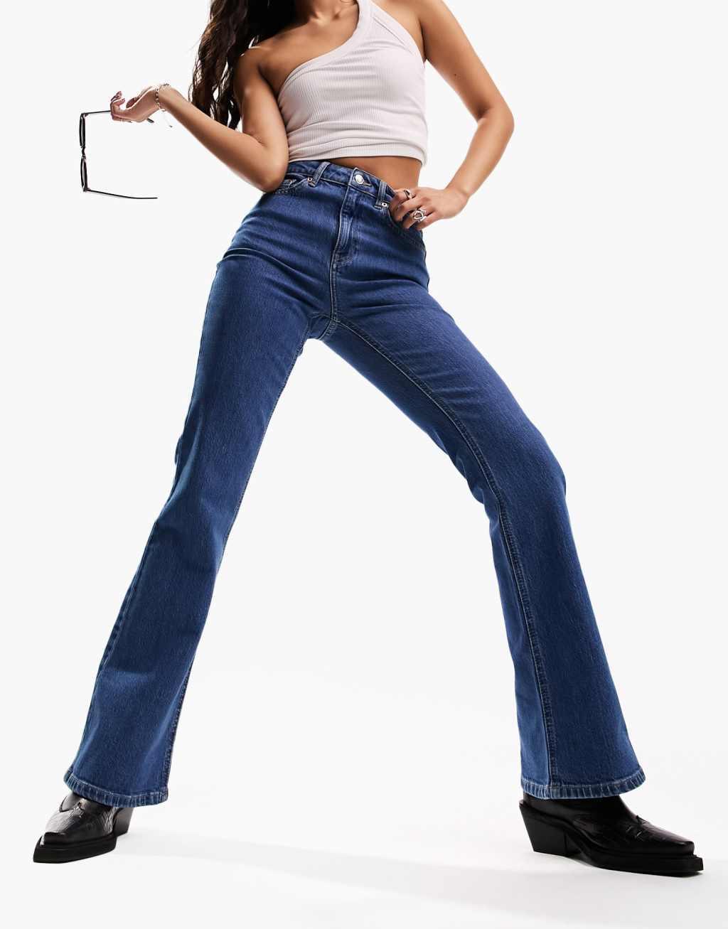 ASOS DESIGN mid rise flare jeans in mid blue Product Image