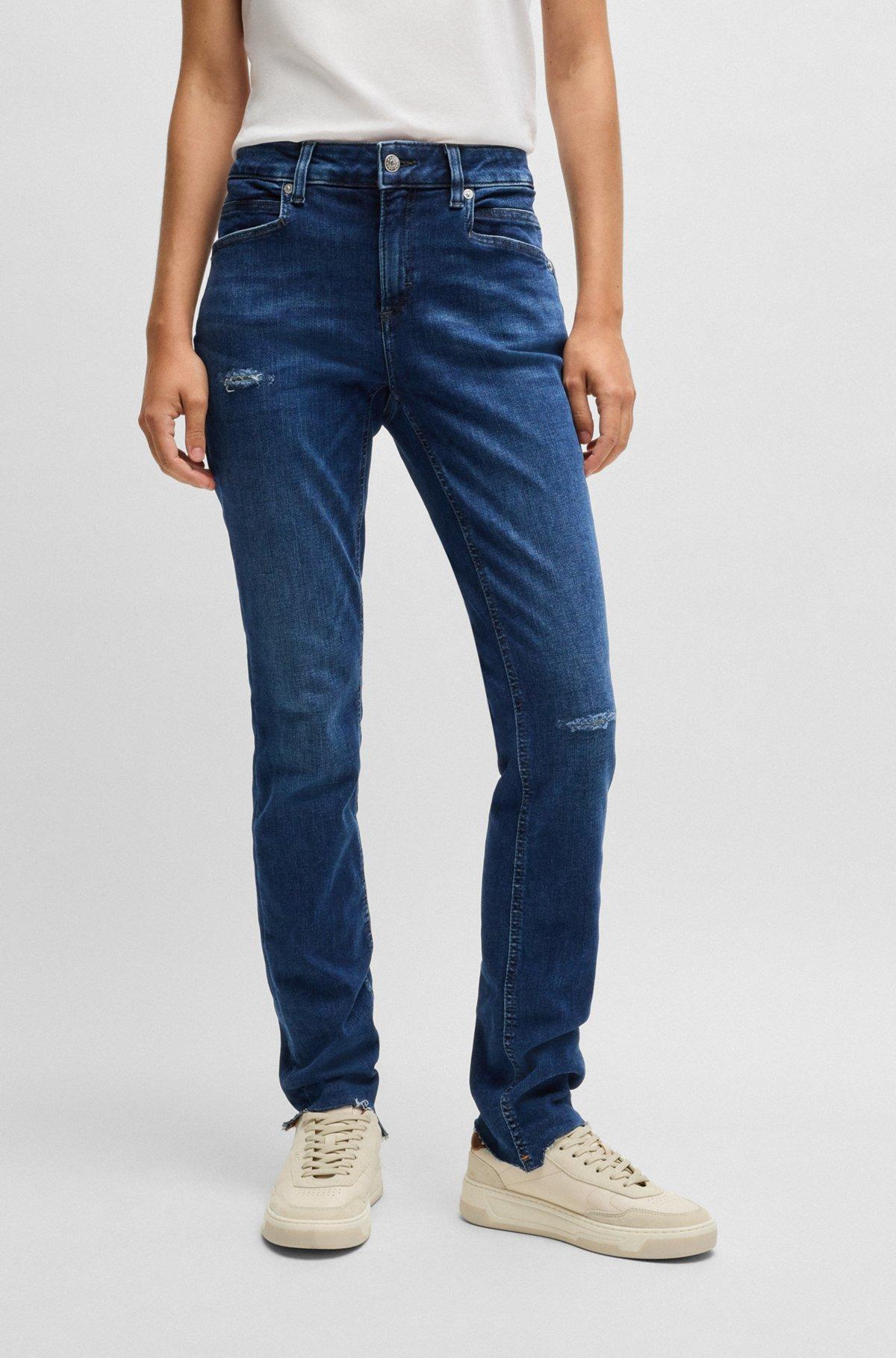 Blue jeans in distressed stretch denim with frayed hems Product Image