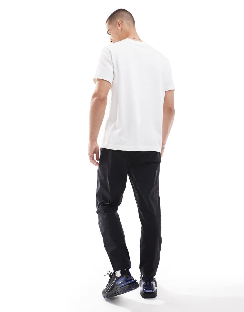 Nike Tech Woven tapered pants in black Product Image