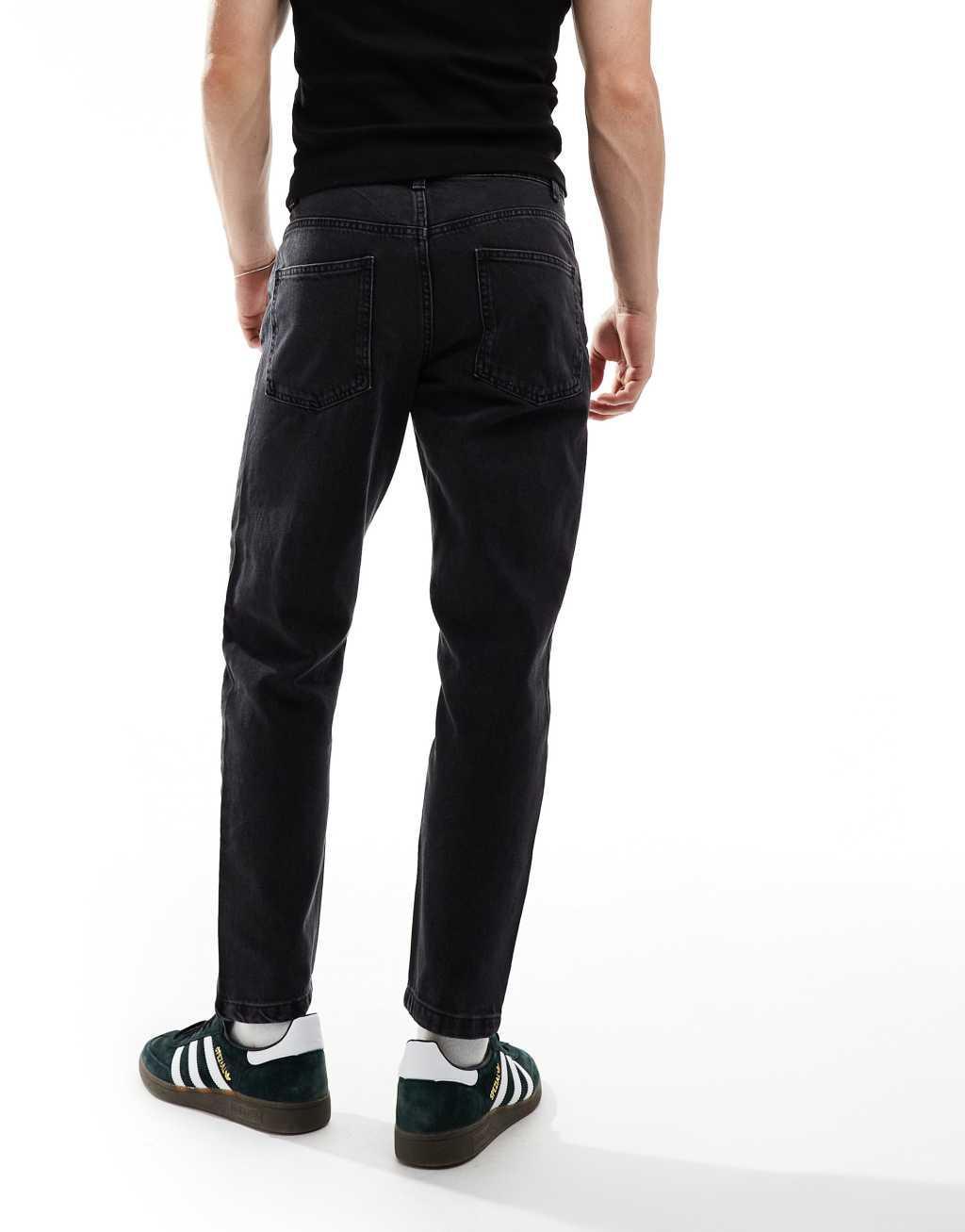 ASOS DESIGN tapered fit jeans with paneling detail in washed black Product Image