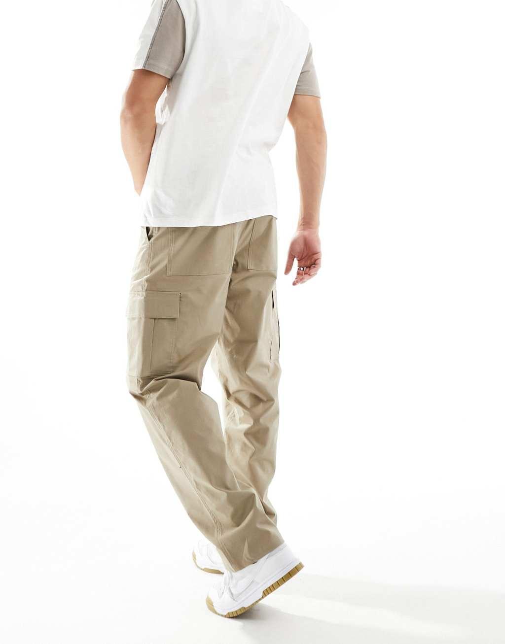 Nike Club woven pants in beige  Product Image