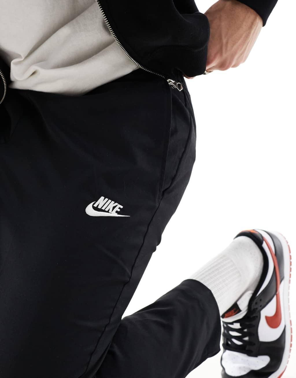 Nike Club woven tapered pants in black Product Image