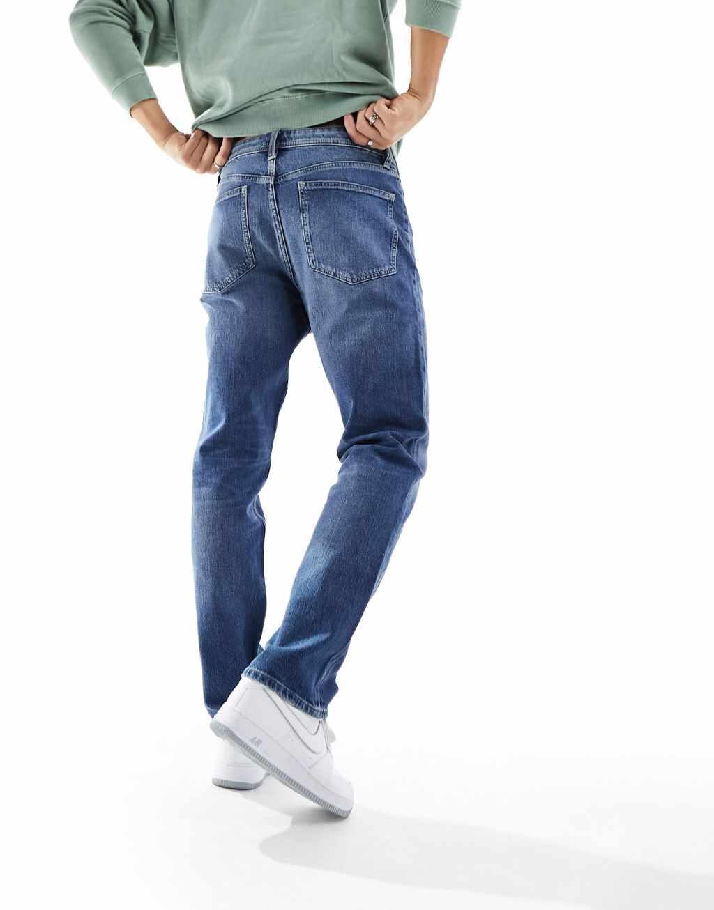 ASOS DESIGN straight leg jeans with stretch in mid wash blue Product Image
