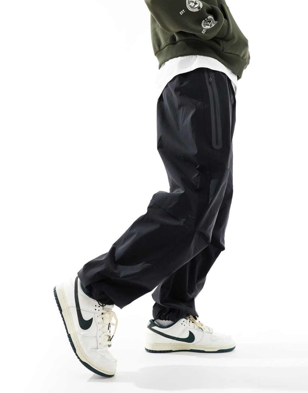 Nike Tech Woven oversized pants in black Product Image