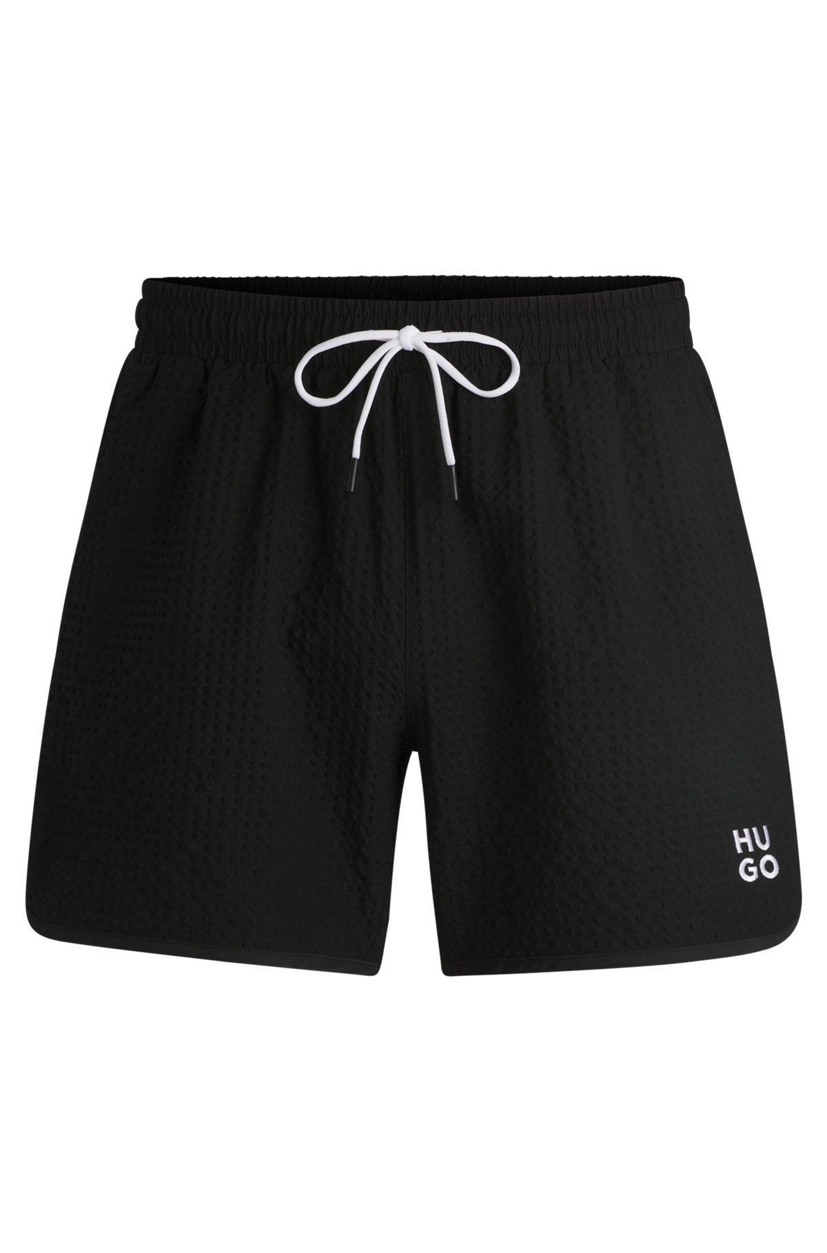 HUGO - Waffle-structured swim shorts with embroidered stacked logo - Black Product Image