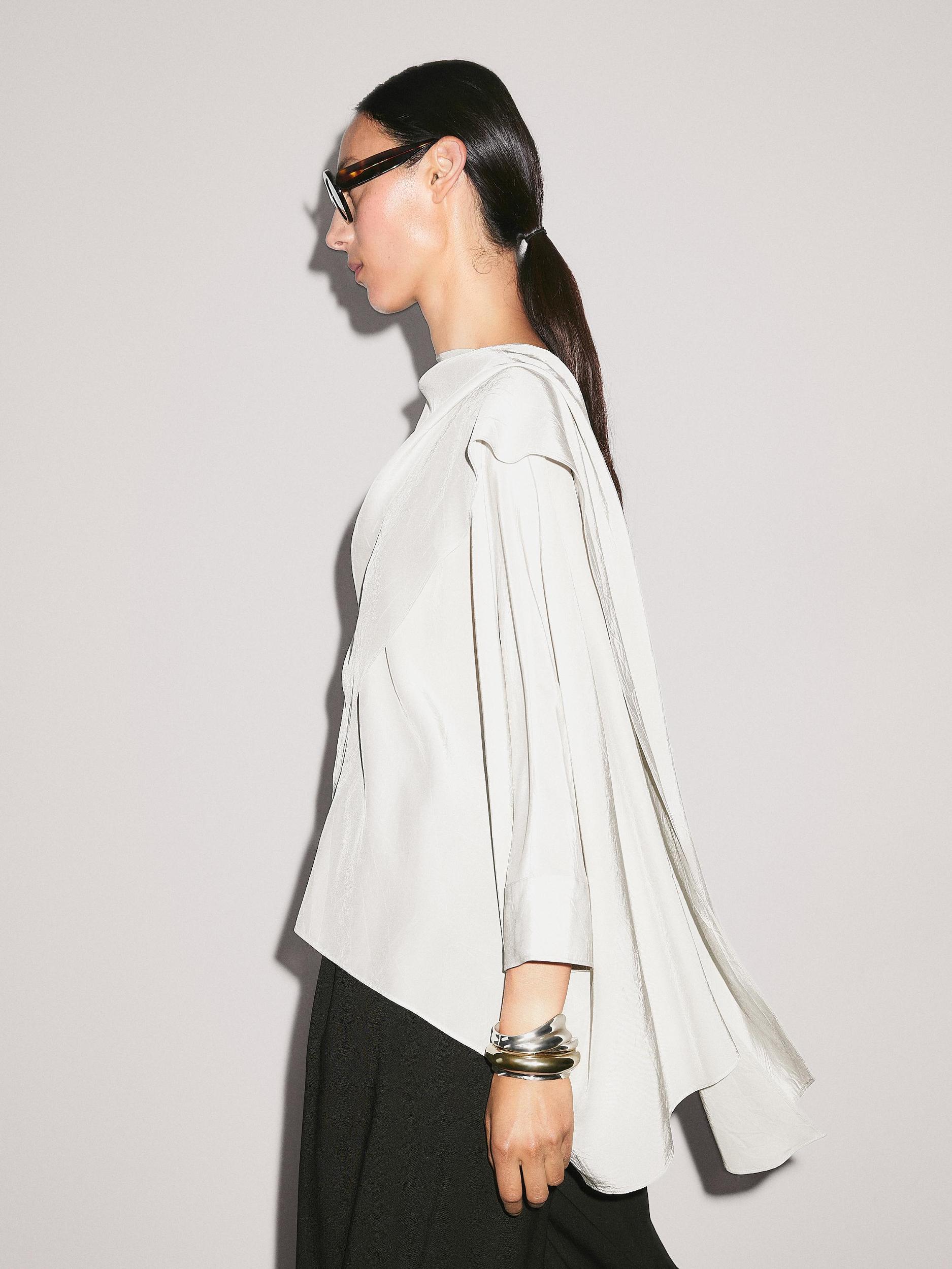 Short flowing cape with sleeve detail Product Image