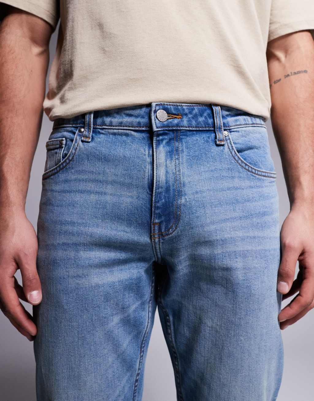 ASOS DSIGN stretch tapered jeans in mid wash with vintage tint Product Image