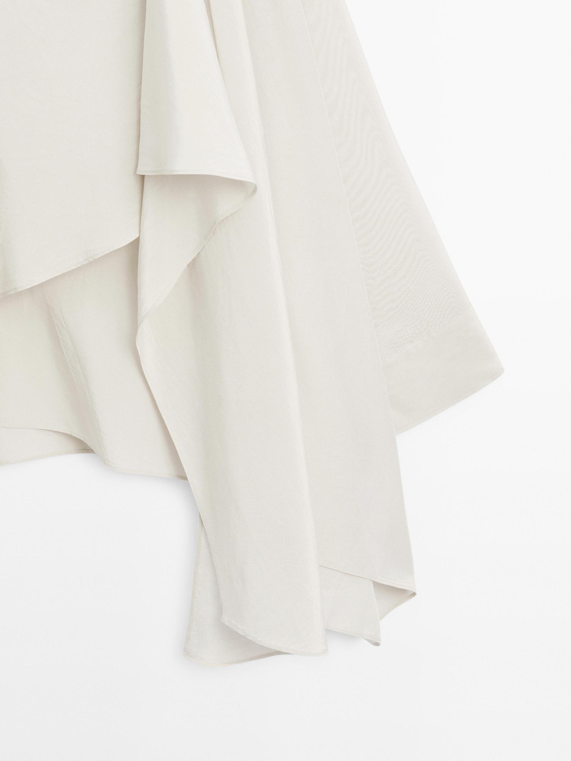 Short flowing cape with sleeve detail Product Image