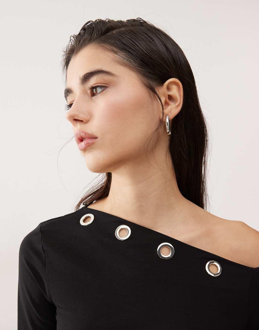 Monki asymmetric shoulder long sleeve top with grommet details in black Product Image