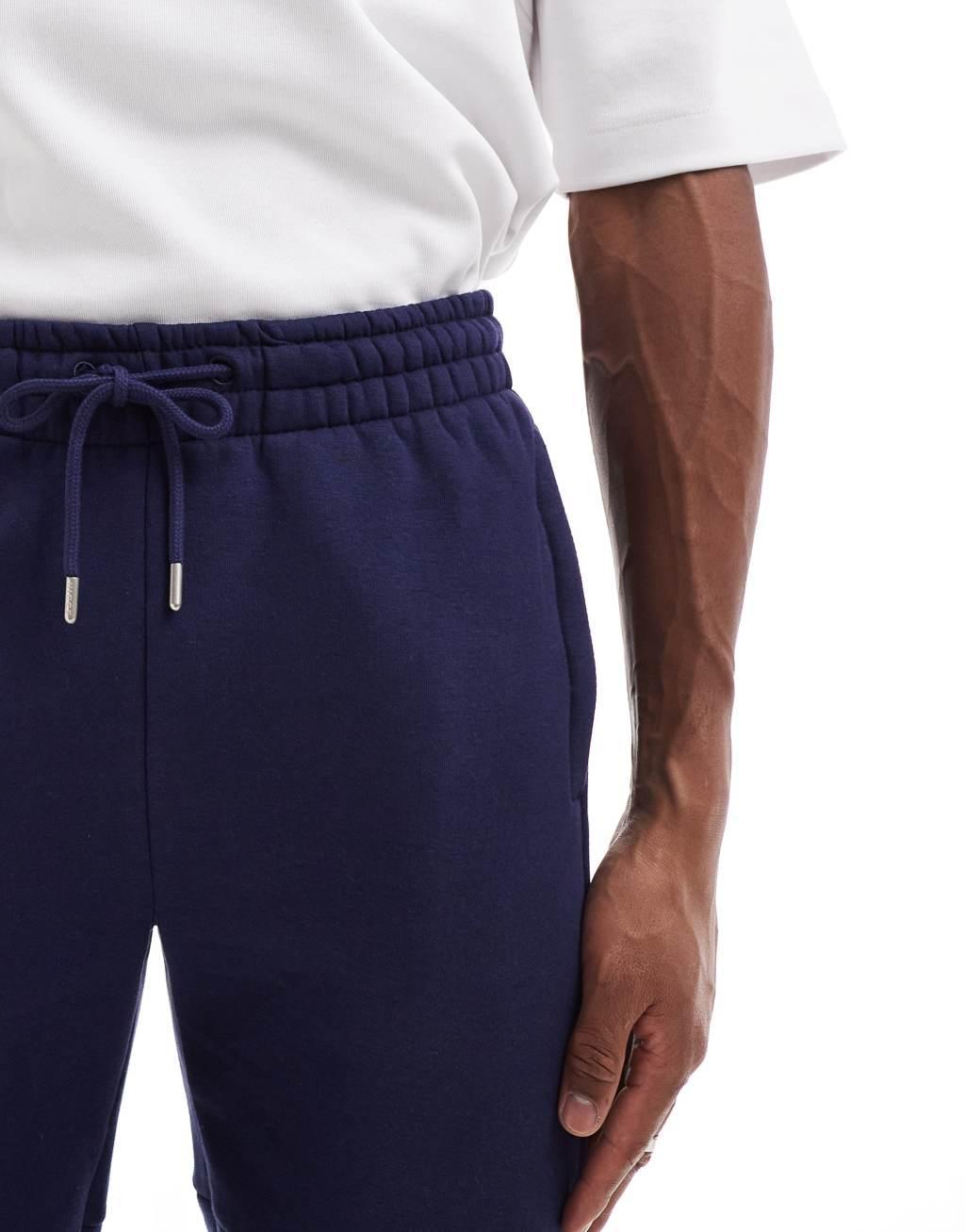 Nicce logo sweatpants in navy Product Image