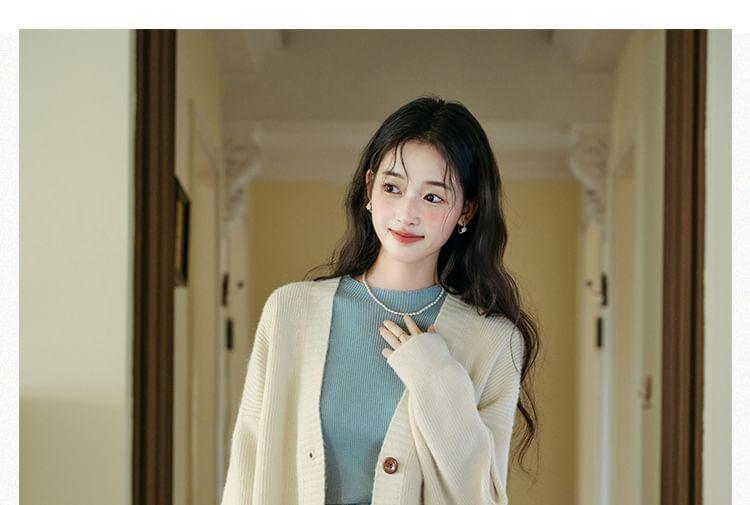 Long-Sleeve Mock Neck Plain Knit Top / V-Neck Cardigan / High Waist Plaid Pleated Midi A-Line Skirt / Set Product Image