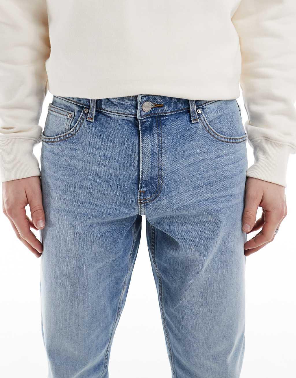 ASOS DESIGN stretch tapered jeans in light wash Product Image