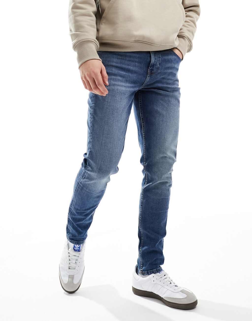 ASOS DESIGN skinny jeans in vintage mid wash blue Product Image