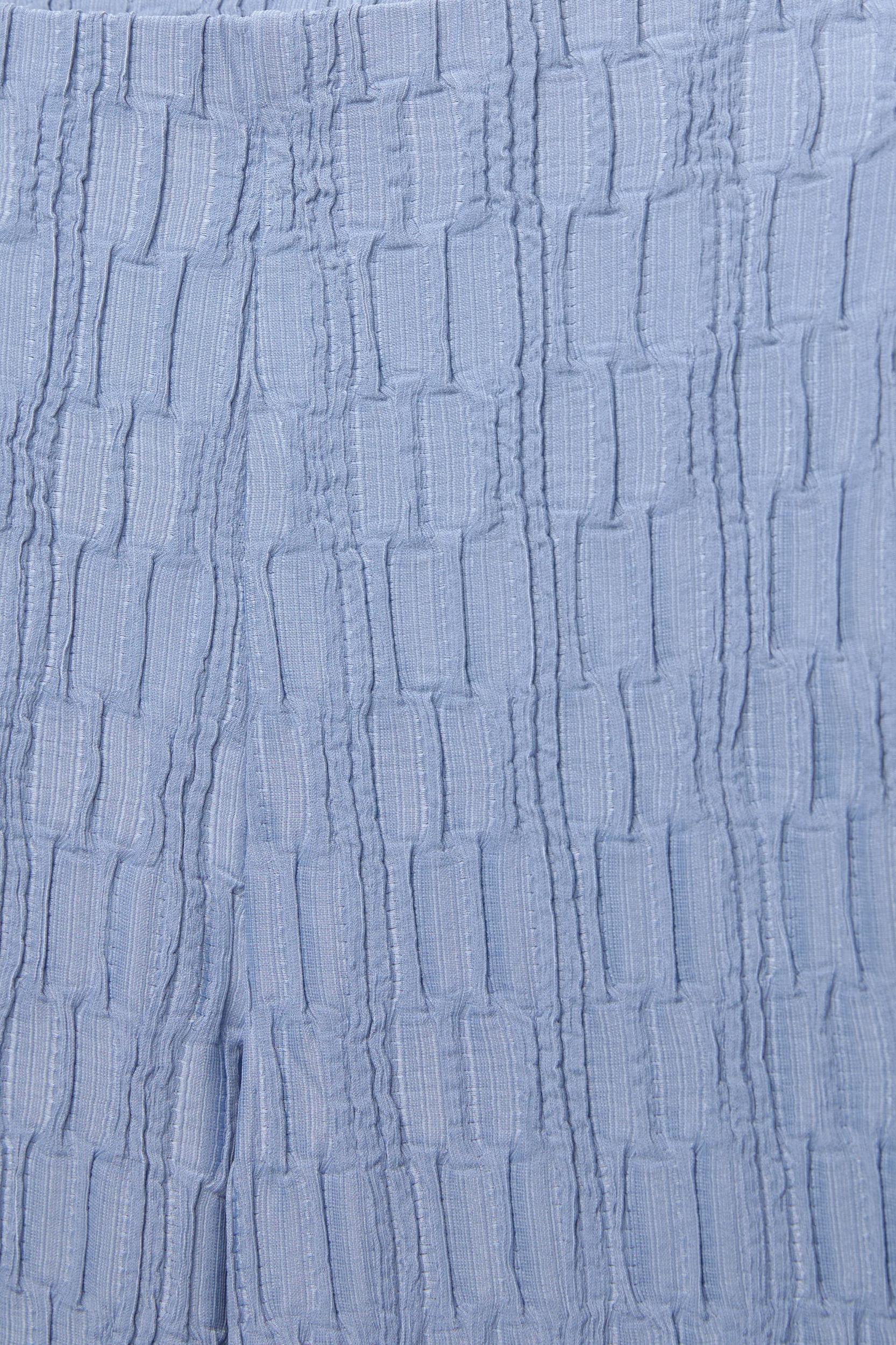 Textured bell bottom trousers Product Image