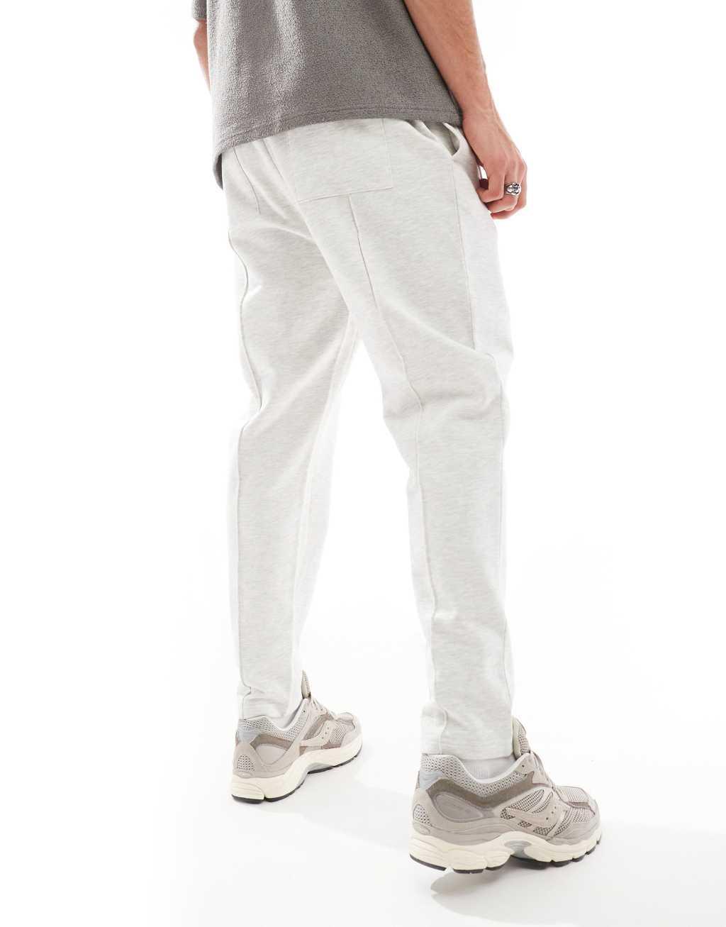 ASOS DESIGN tapered sweatpants with zip fastening in heather gray Product Image