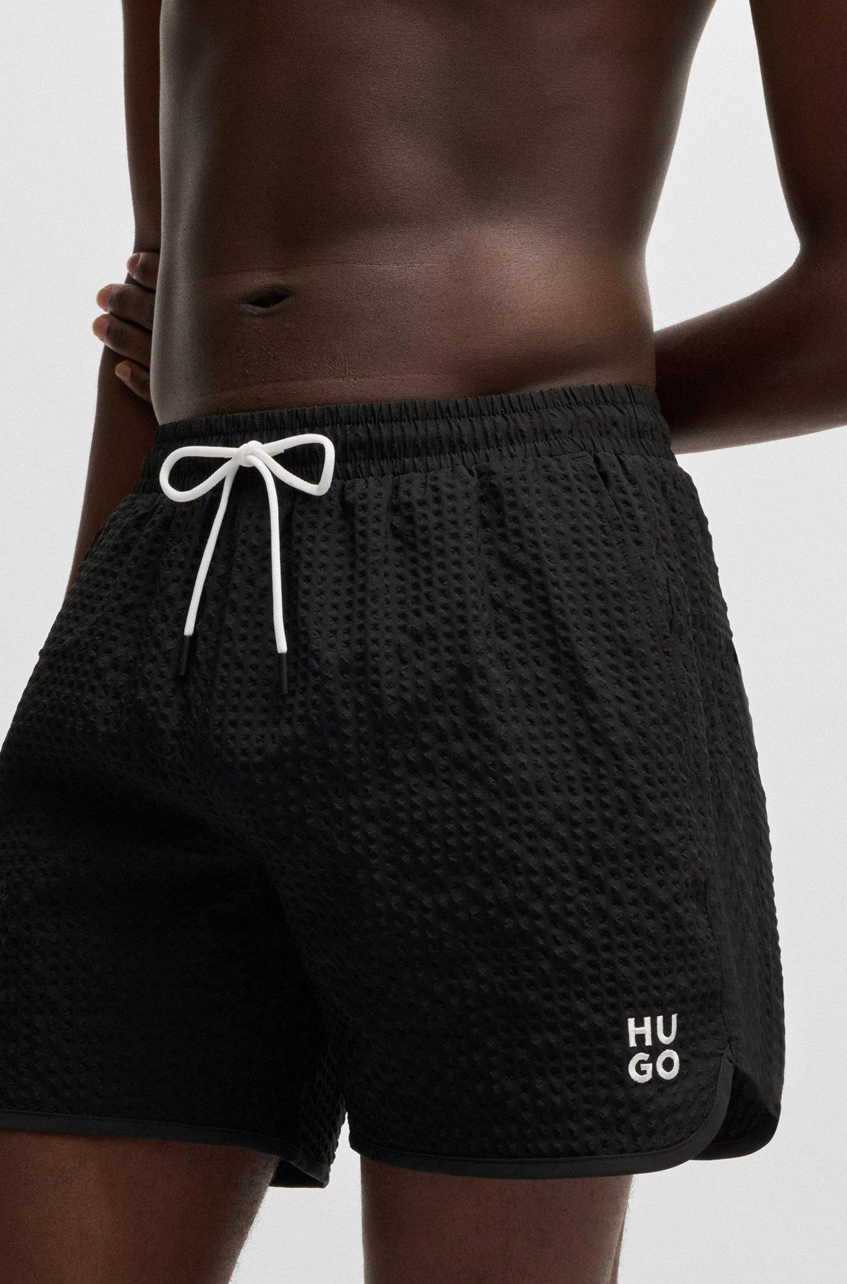 HUGO - Waffle-structured swim shorts with embroidered stacked logo - Black Product Image