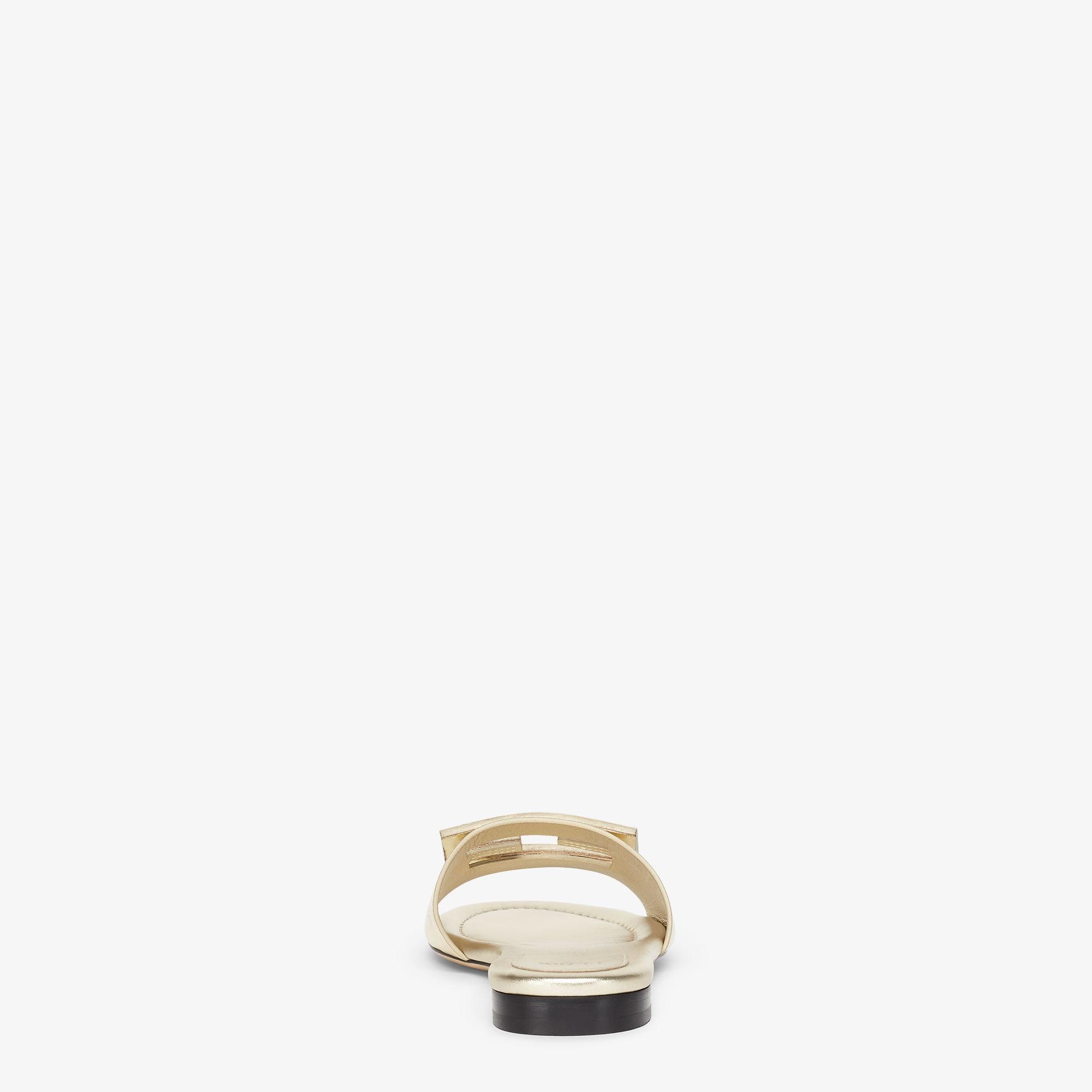 BaguetteMetallic champagne-colored leather slides Product Image