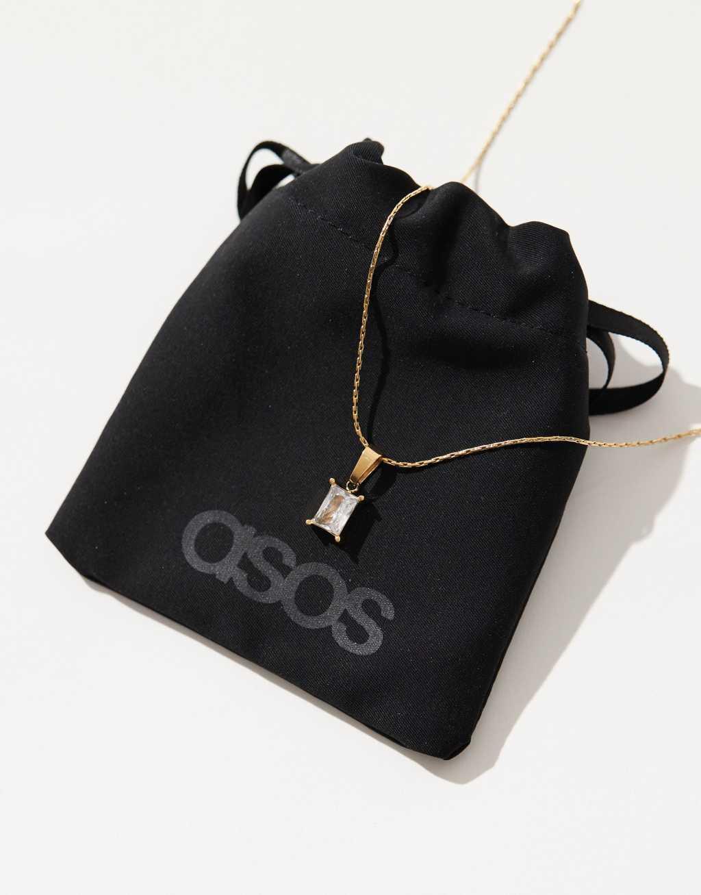 ASOS DESIGN stainless steel necklace with cubic zirconia pendant in gold tone with gift bag Product Image