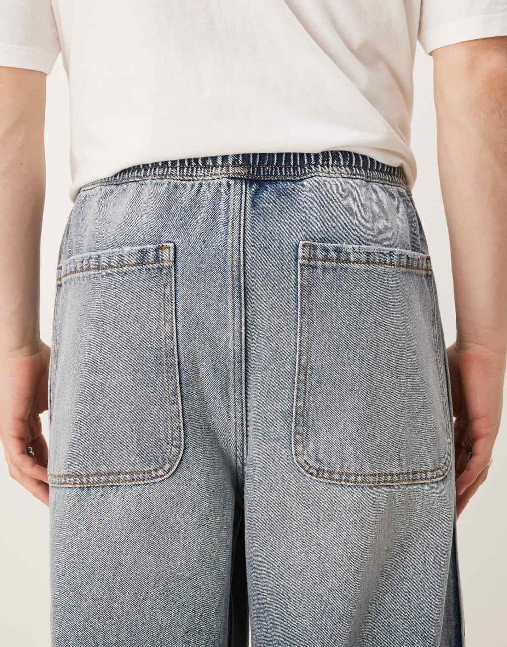 ASOS DESIGN super baggy jeans with elastic waist in mid wash blue Product Image