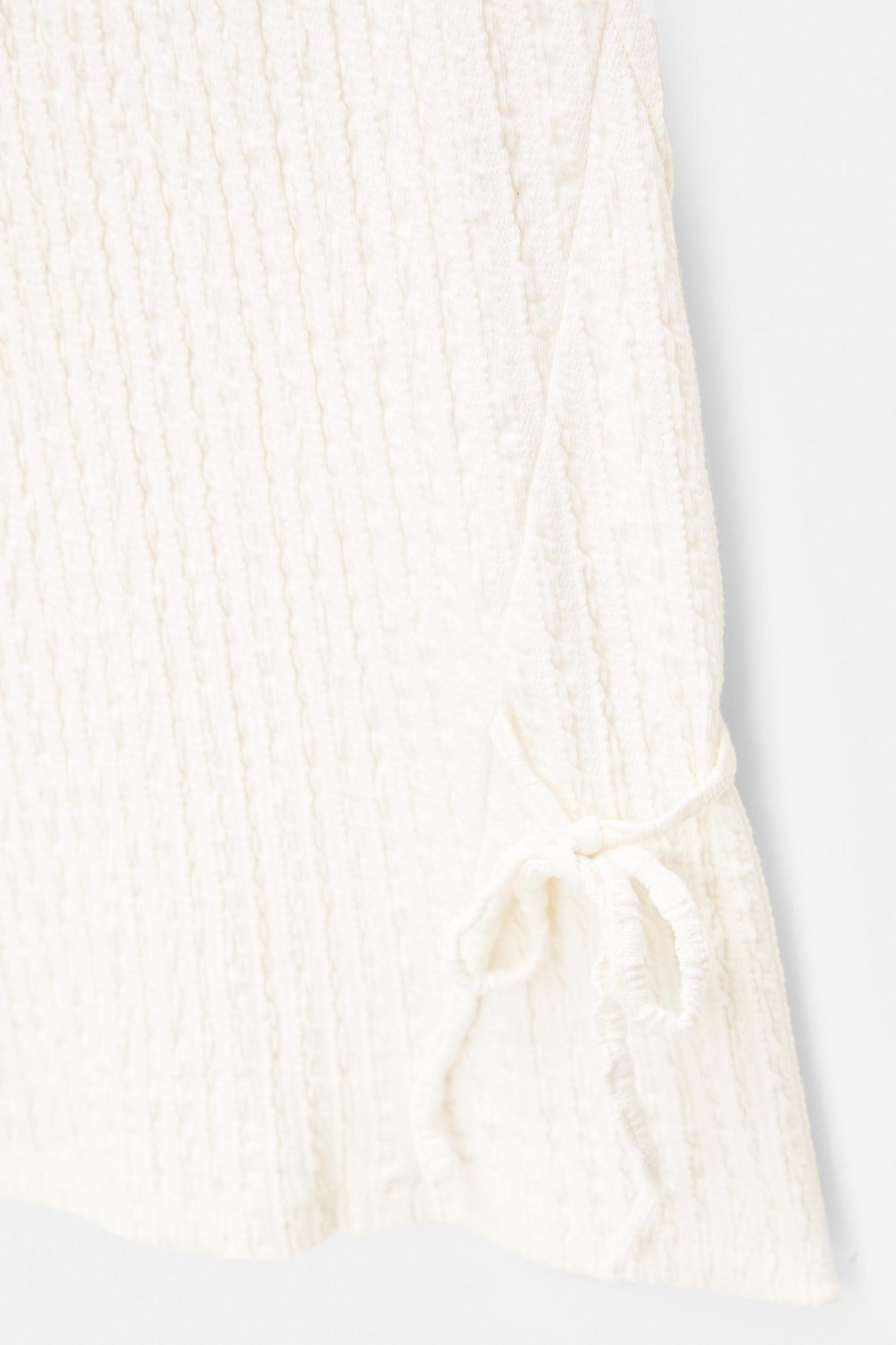 Rustic trousers with knot detail Product Image