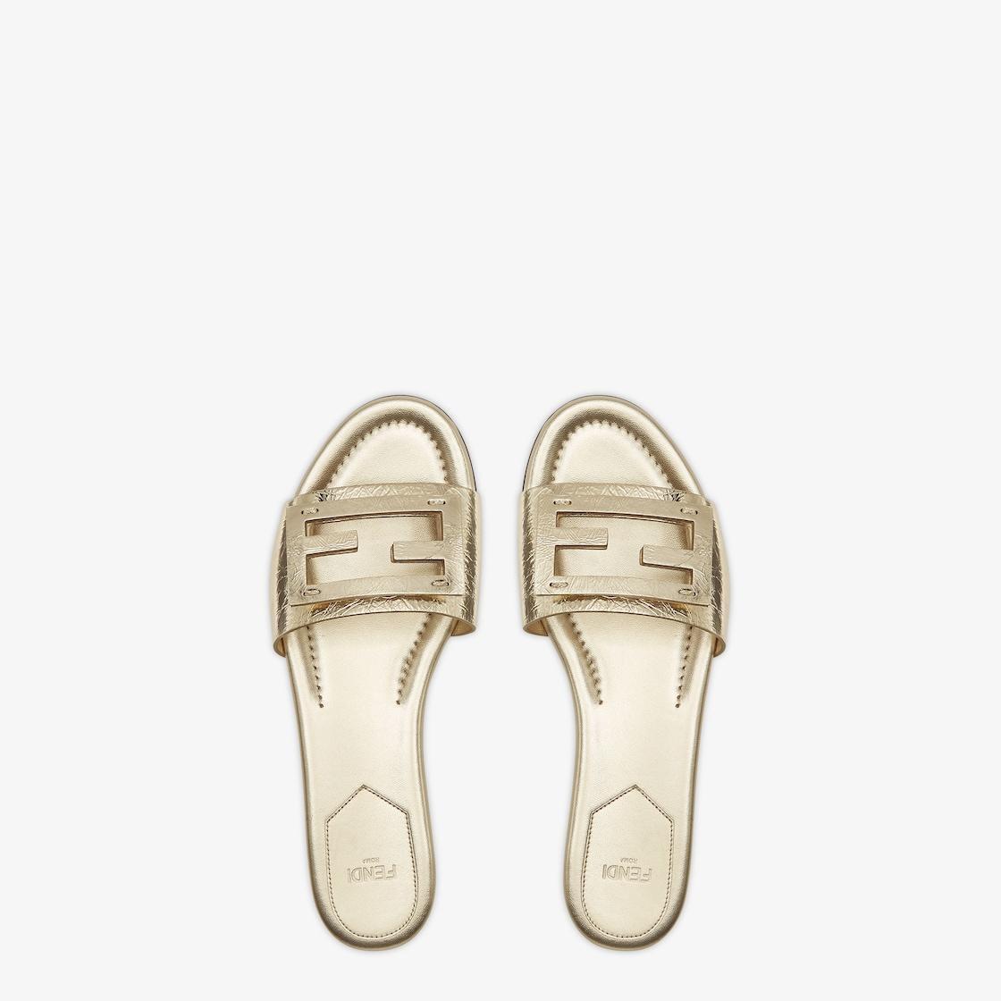 BaguetteMetallic champagne-colored leather slides Product Image