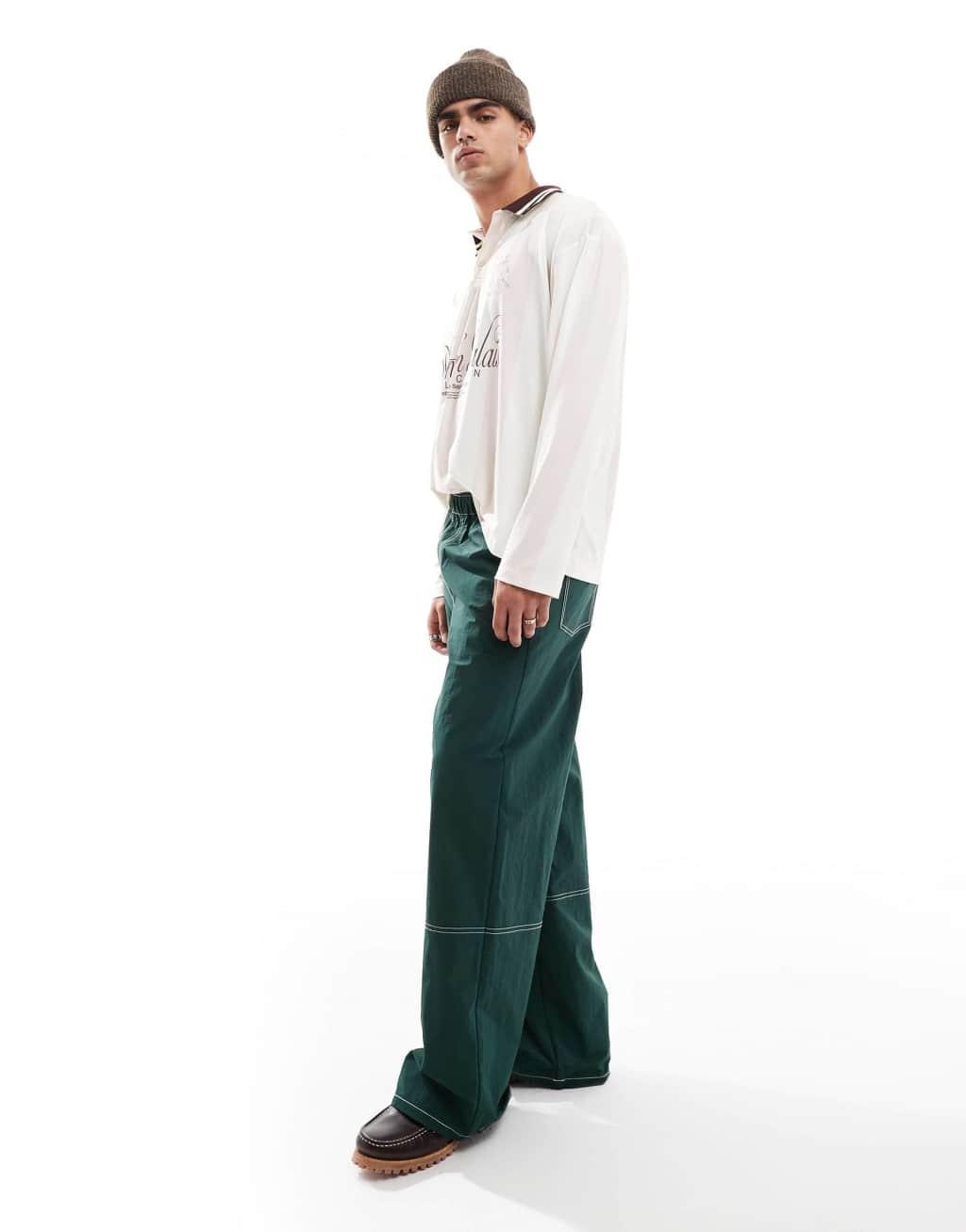 ASOS DESIGN baggy pants in green nylon with contrast stitch Product Image