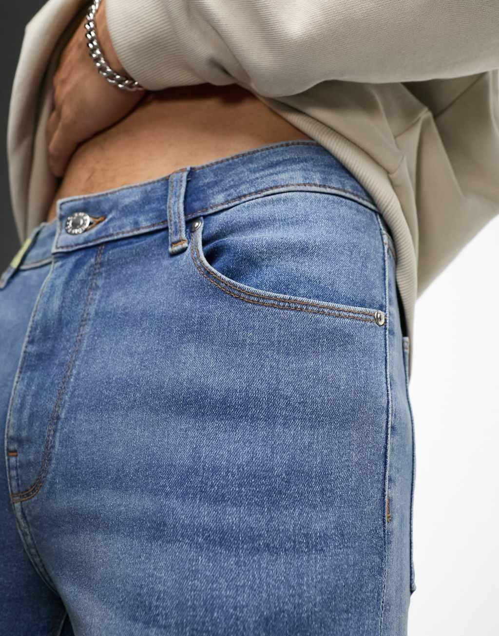 ASOS DESIGN power stretch jeans in mid wash blue Product Image