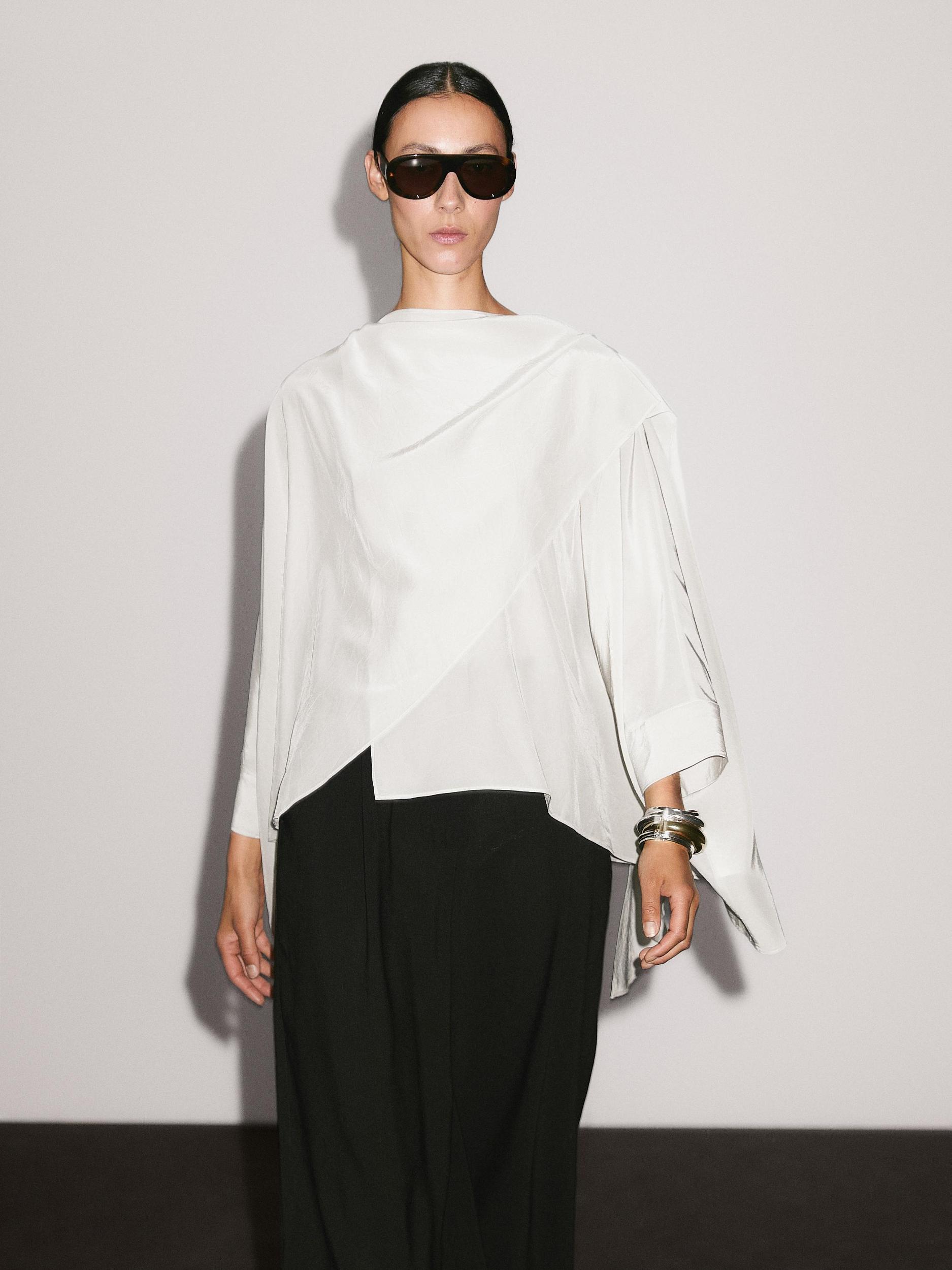 Short flowing cape with sleeve detail Product Image