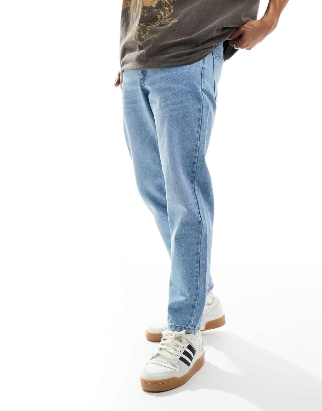 ASOS DESIGN tapered fit jeans in light wash blue  Product Image