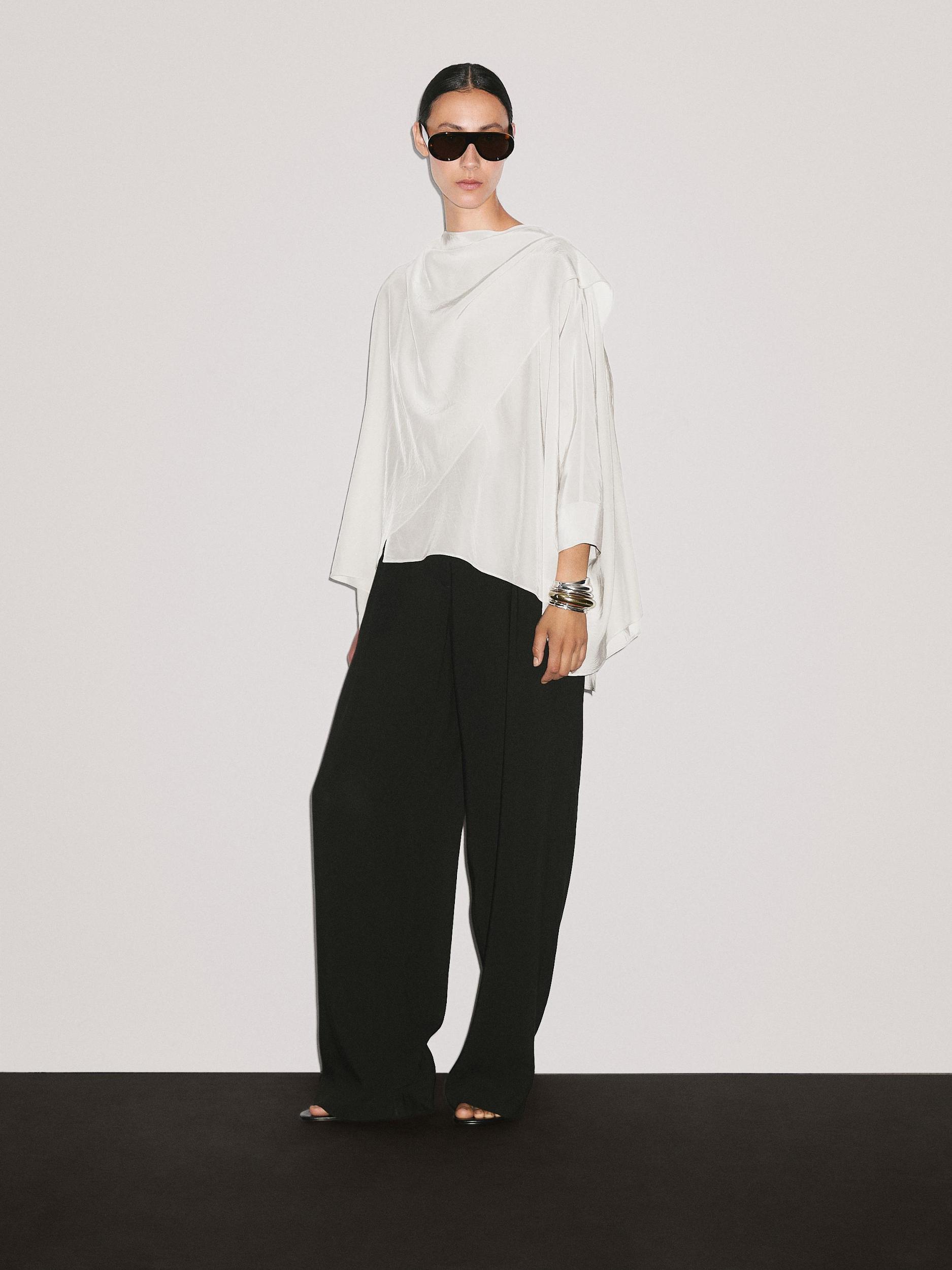 Short flowing cape with sleeve detail Product Image