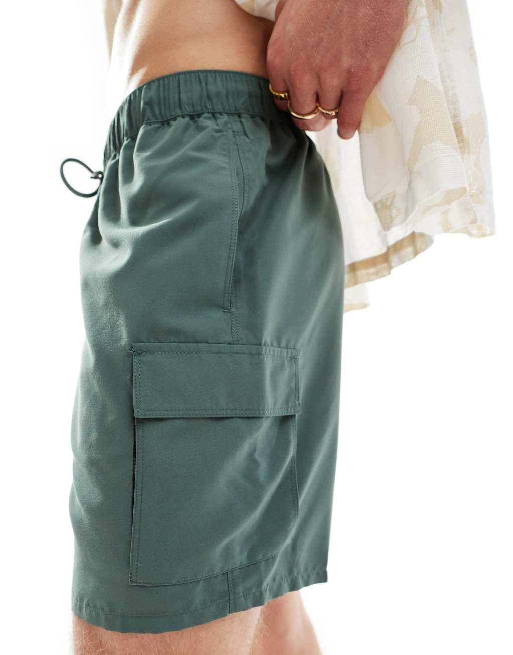 ASOS DESIGN swim shorts in mid length with cargo pockets in khaki Product Image