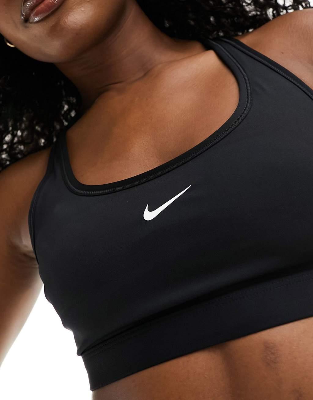 Nike Training Swoosh light support sports bra in black Product Image