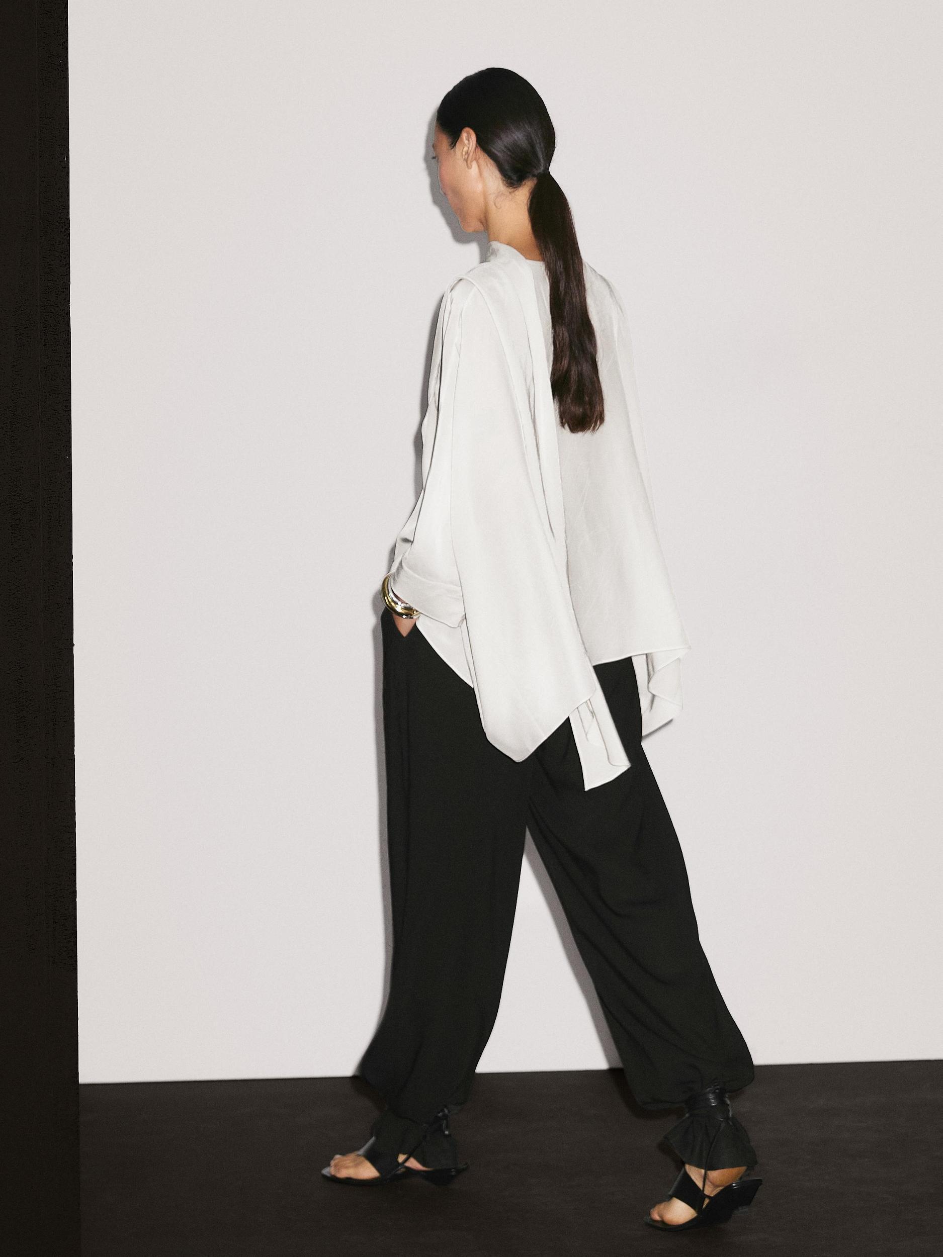 Short flowing cape with sleeve detail Product Image