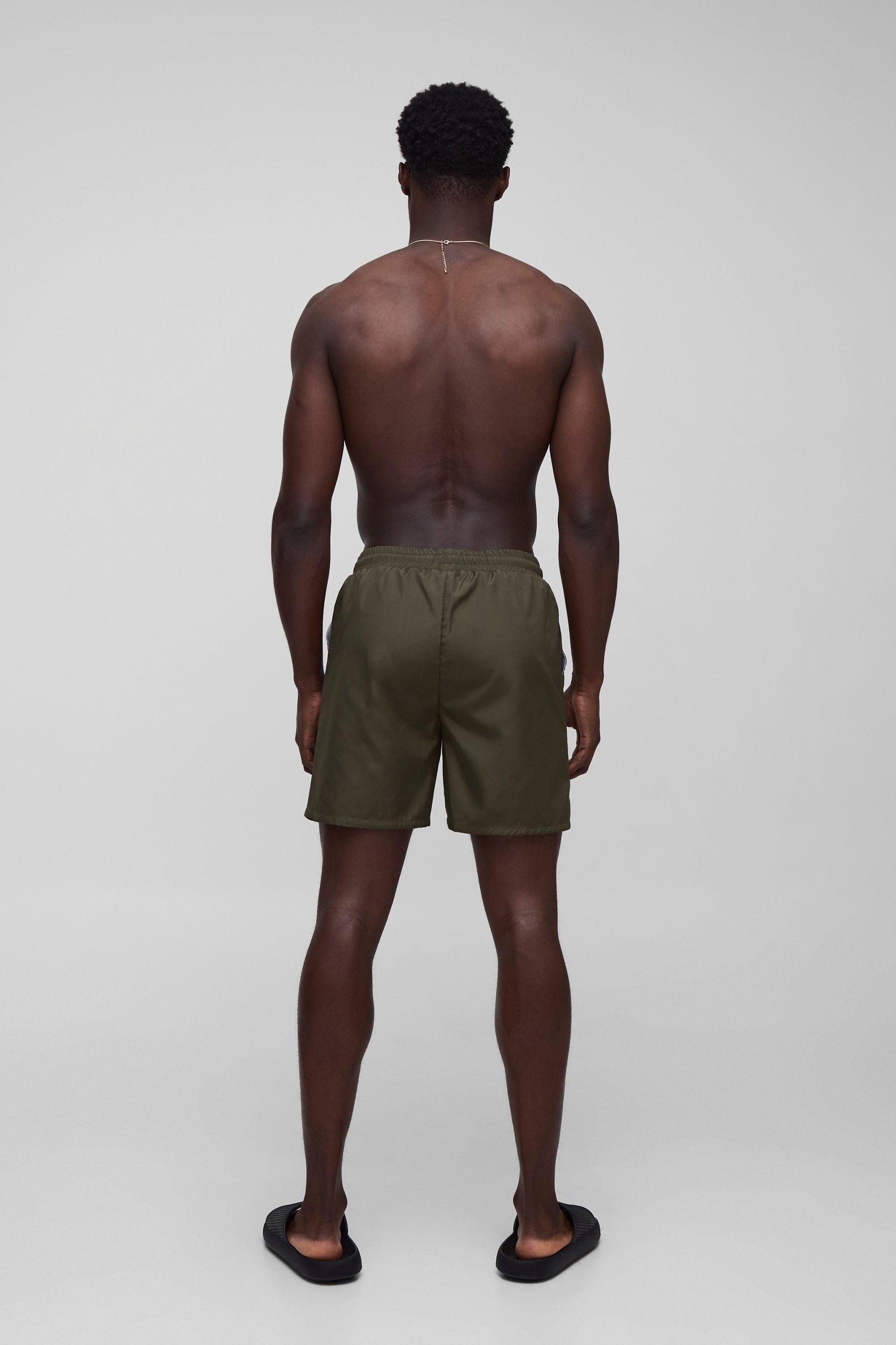 Regular fit Mid length Plain Swim Shorts | boohooMAN USA Product Image