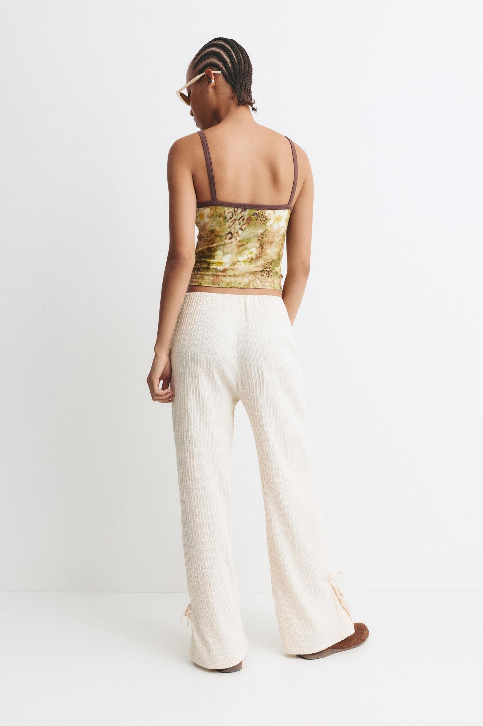 Rustic trousers with knot detail Product Image