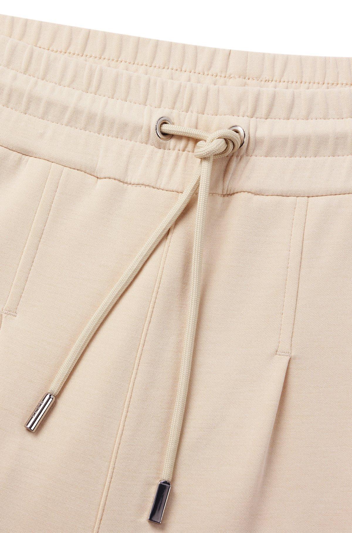 Wide-leg tracksuit bottoms with pleat details Product Image