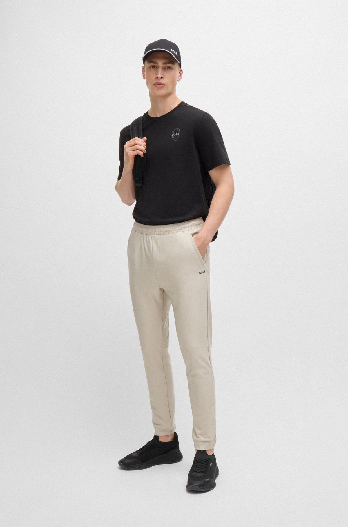 Tracksuit bottoms in stretch fabric with decorative reflective logo Product Image