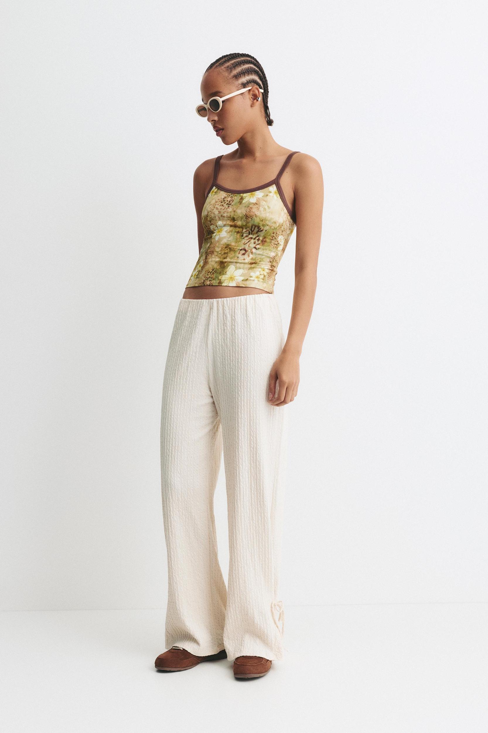 Rustic trousers with knot detail Product Image