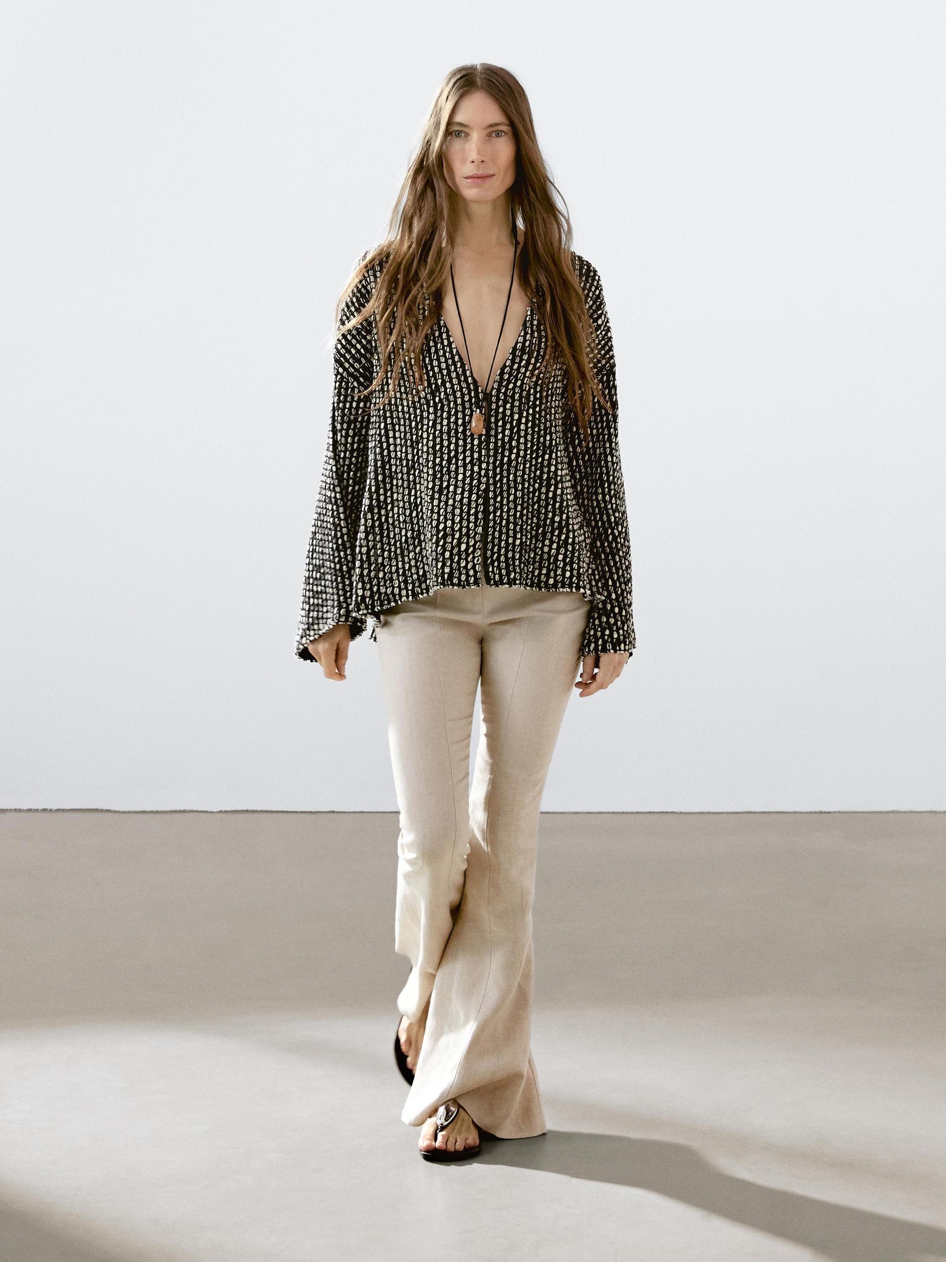 Flared trousers with contrast waist Product Image