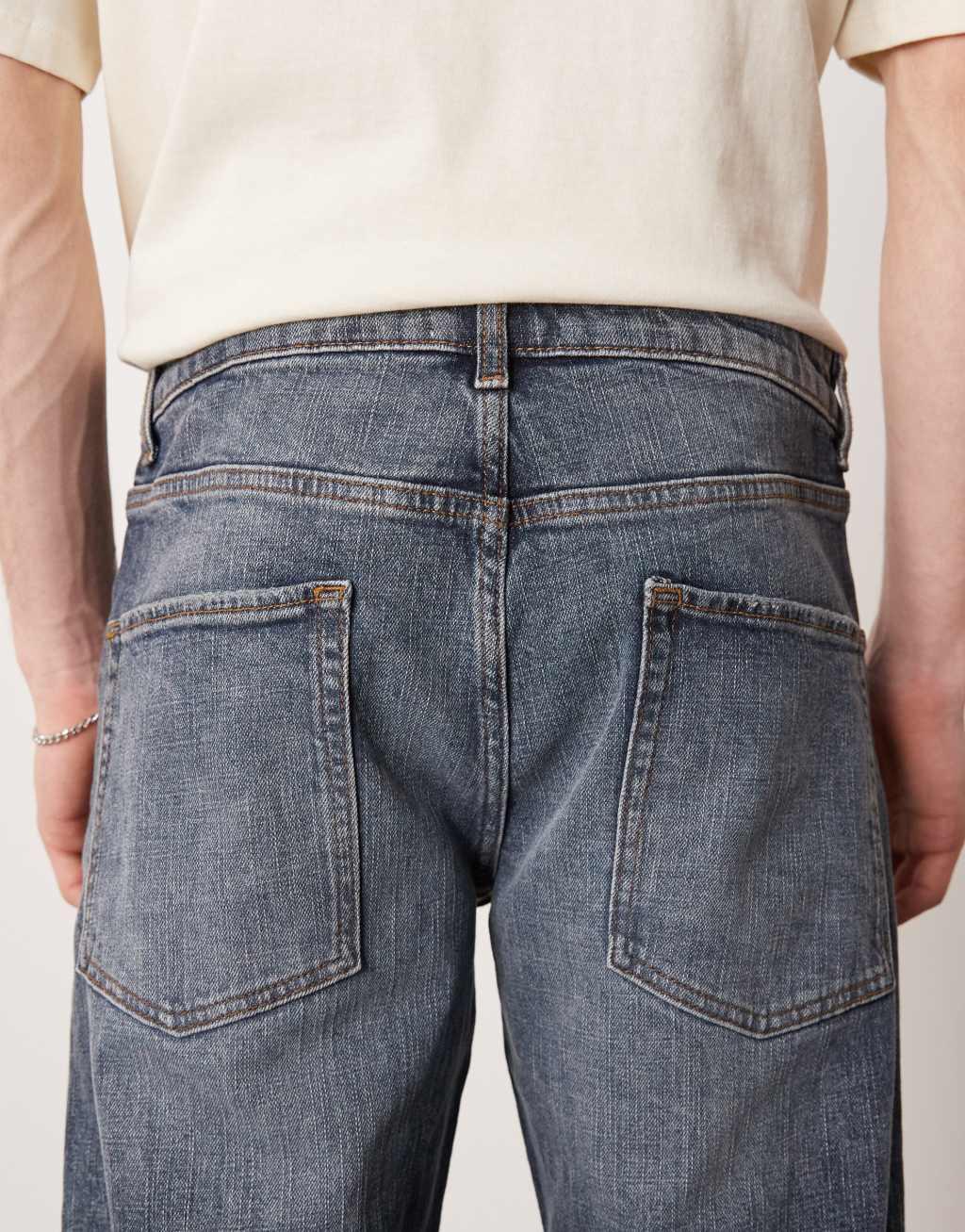 ASOS DESIGN stretch tapered jeans in mid wash blue Product Image