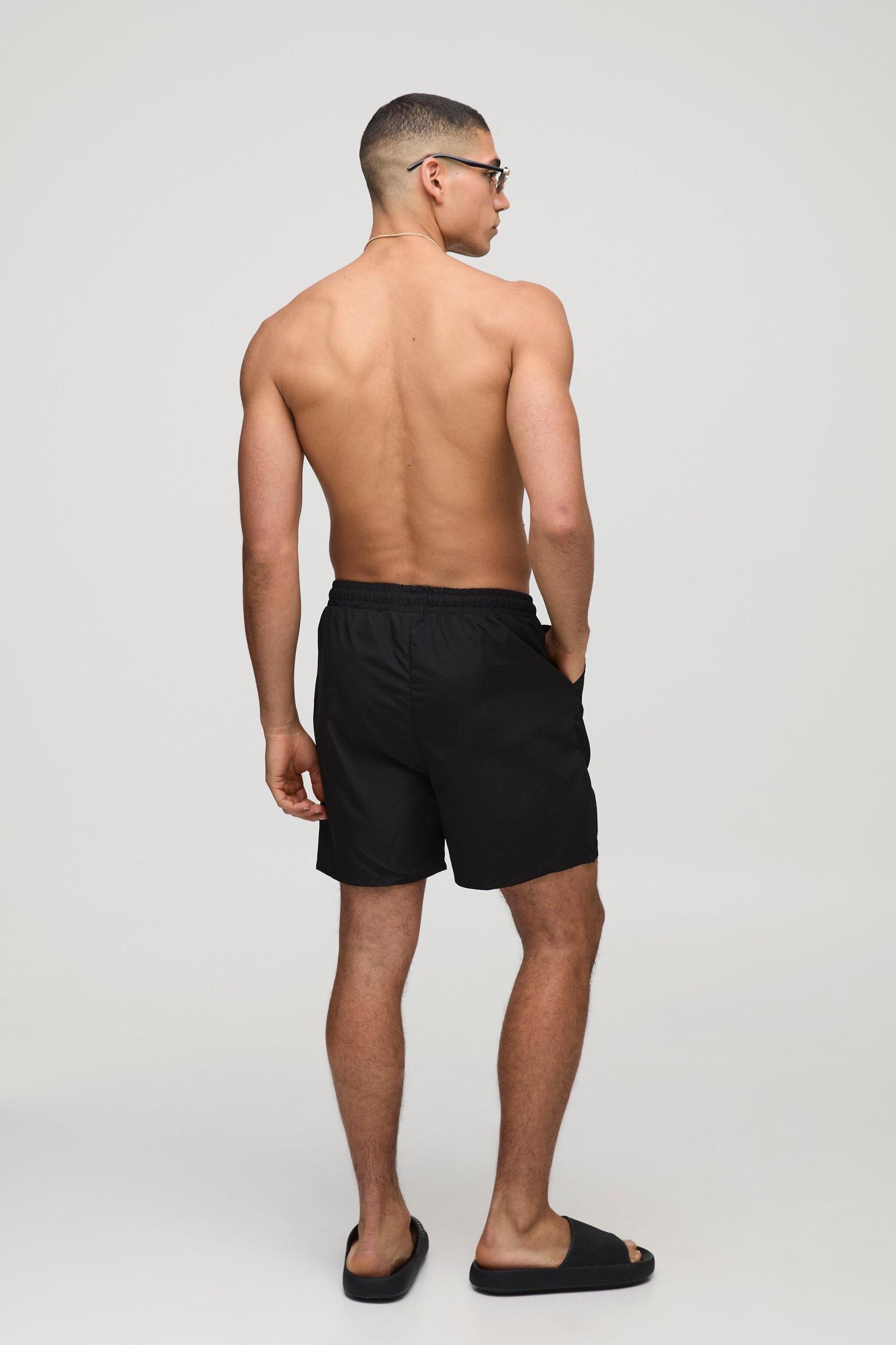 Branded Regular fit Mid length Embroidered Swim Shorts | boohooMAN USA Product Image