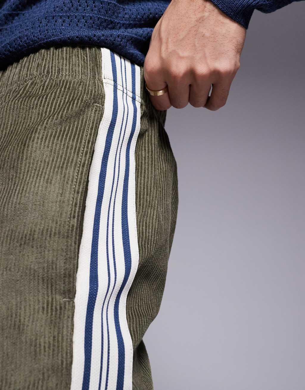 ASOS DESIGN pull on relaxed pants in green corduroy with stripe detail Product Image