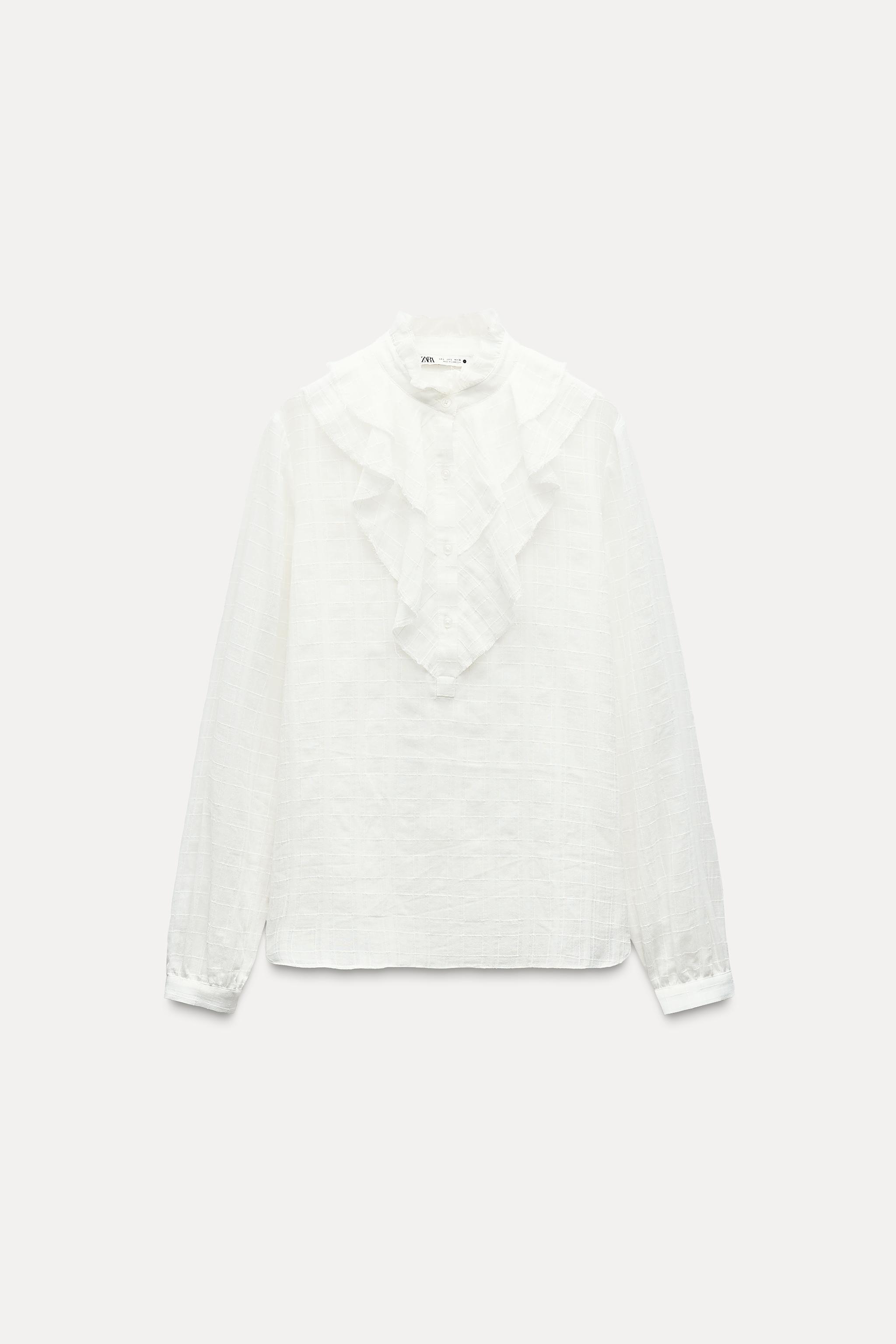 ZARA WOMAN COLLECTION<br/><br/>Blouse made with cotton. Round neck and long sleeves. Self ruffle detail. Front button closure. Product Image