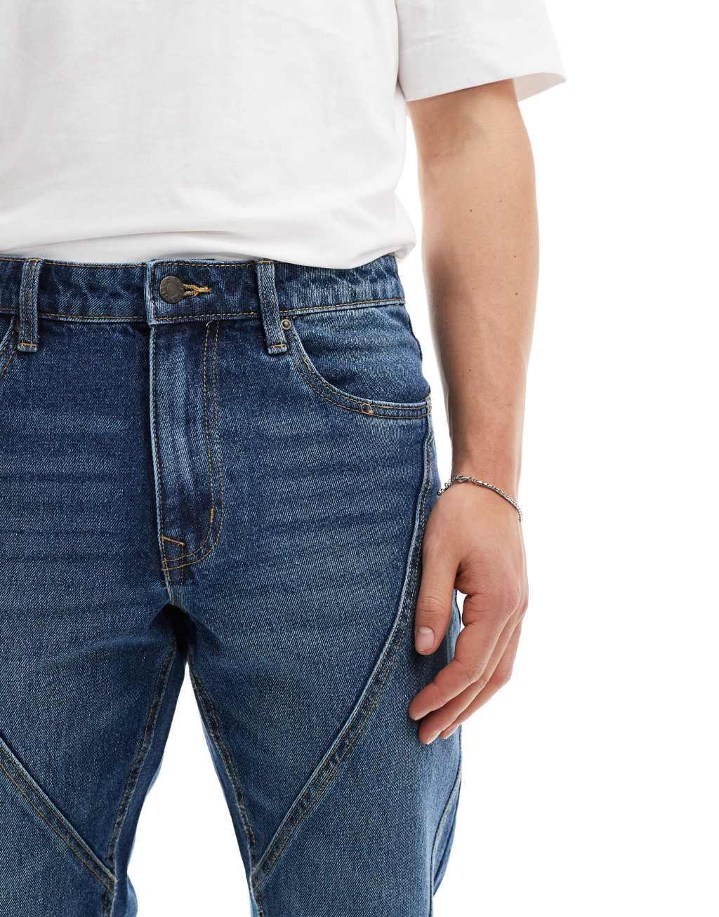 ASOS DESIGN tapered fit jeans with paneling detail in mid wash blue  Product Image