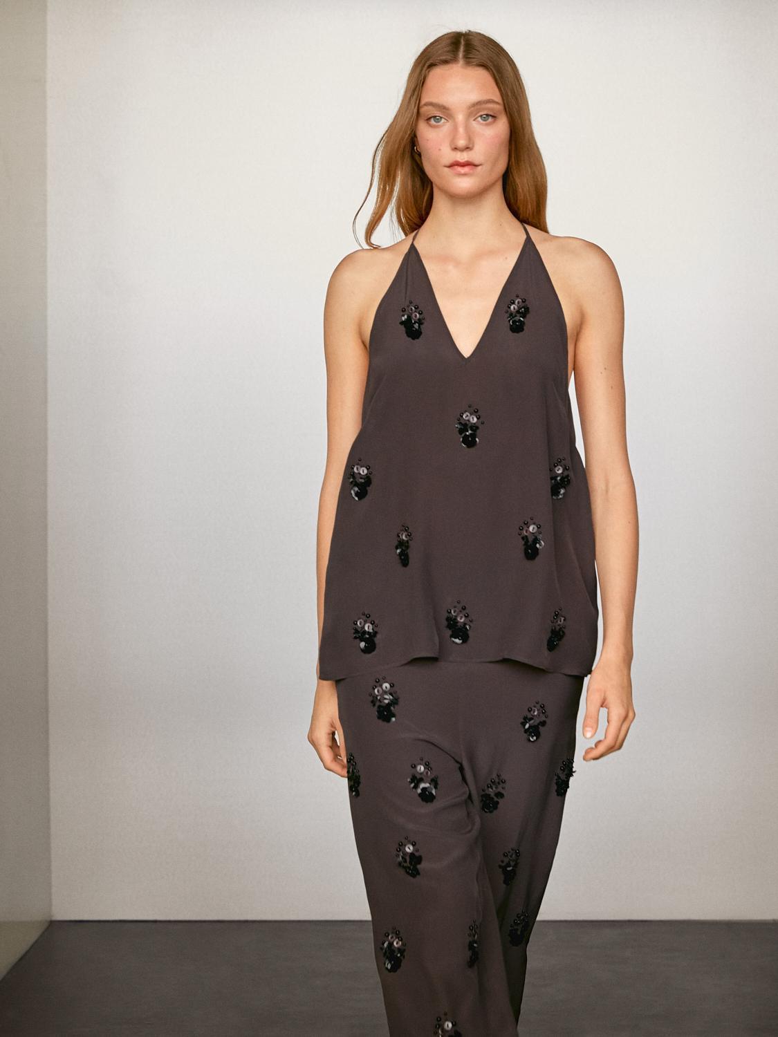 Flowing trousers with floral appliqués Product Image