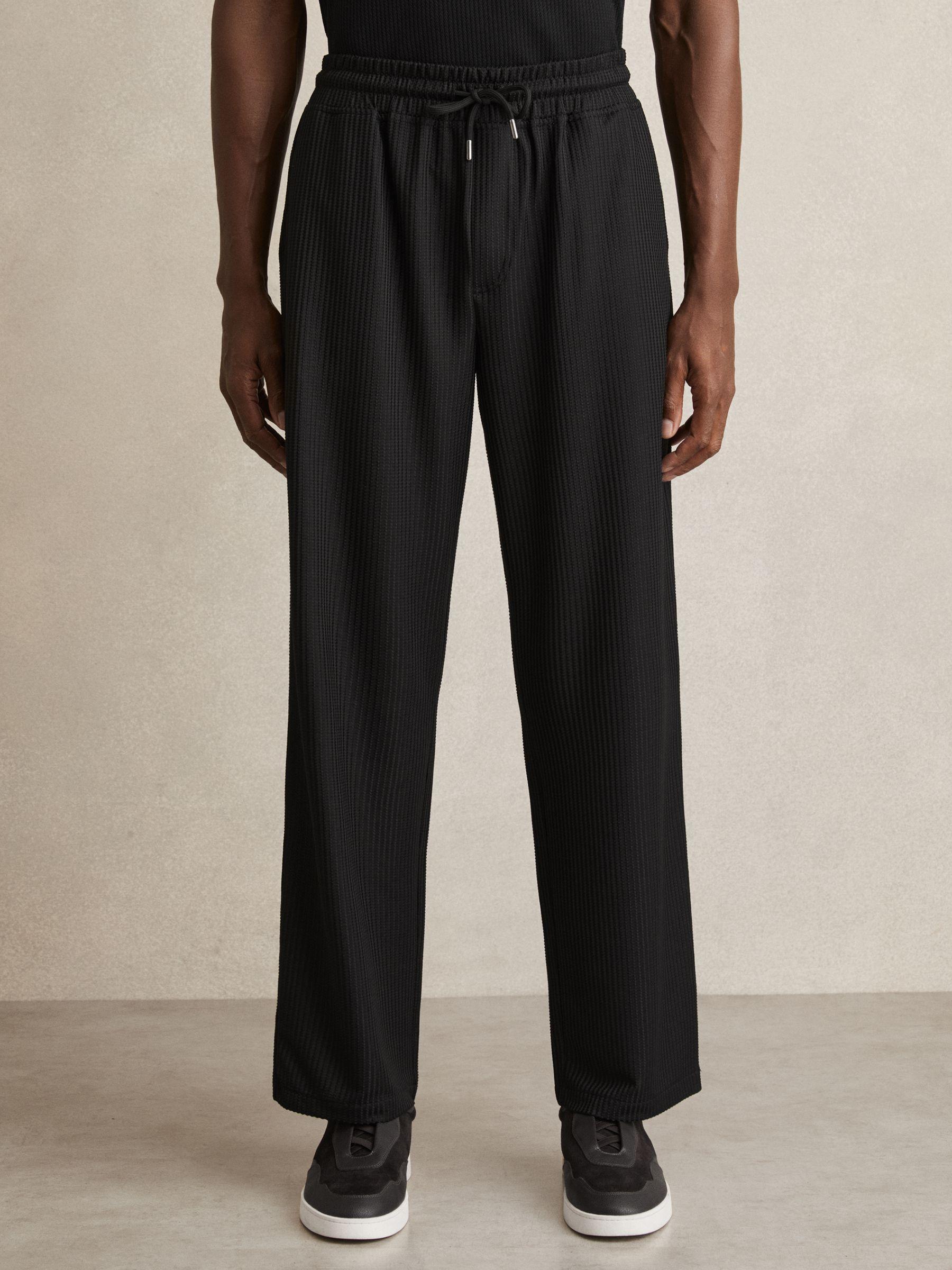 Textured-Knit Tapered Trousers in Black Product Image