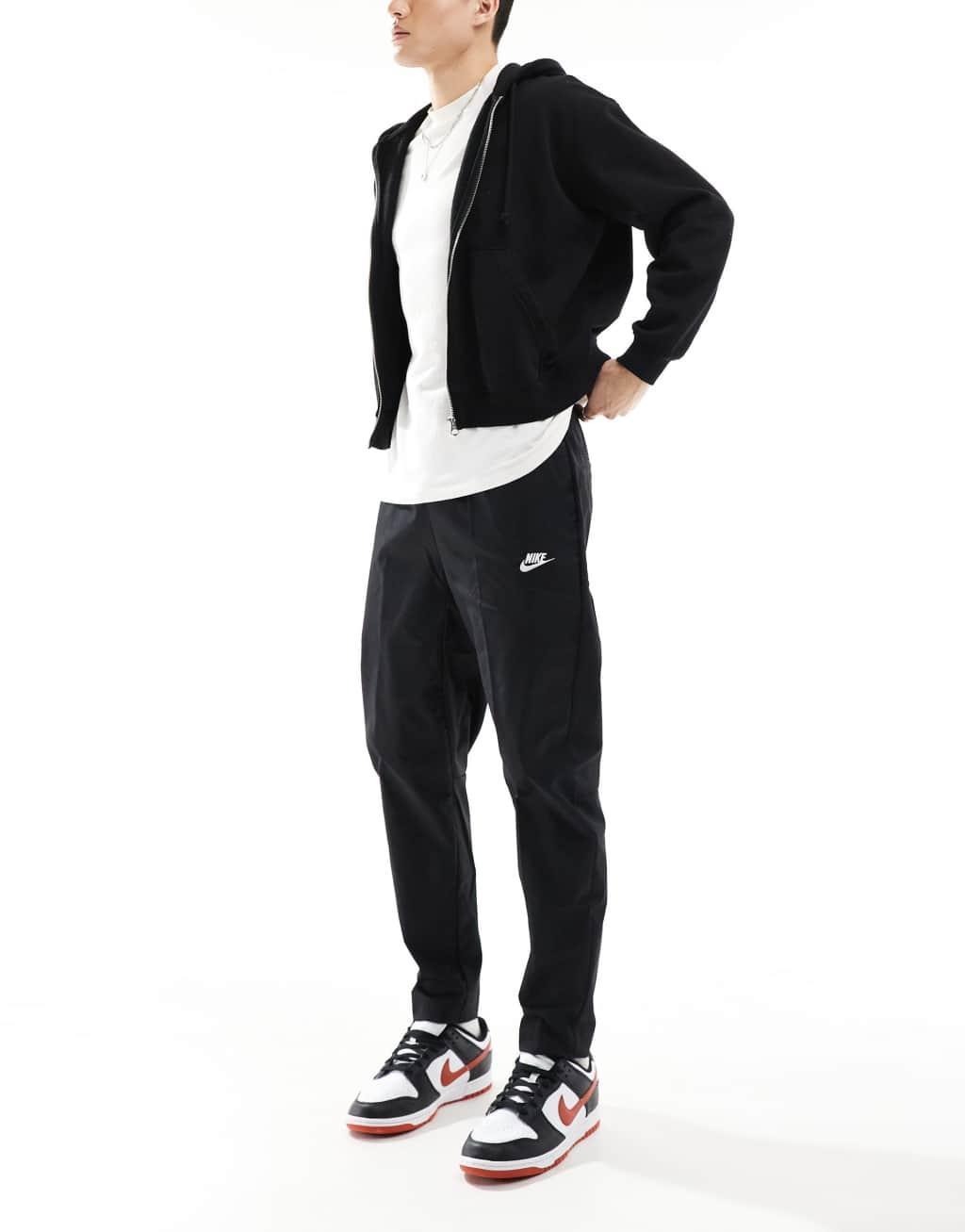 Nike Club woven tapered pants in black Product Image